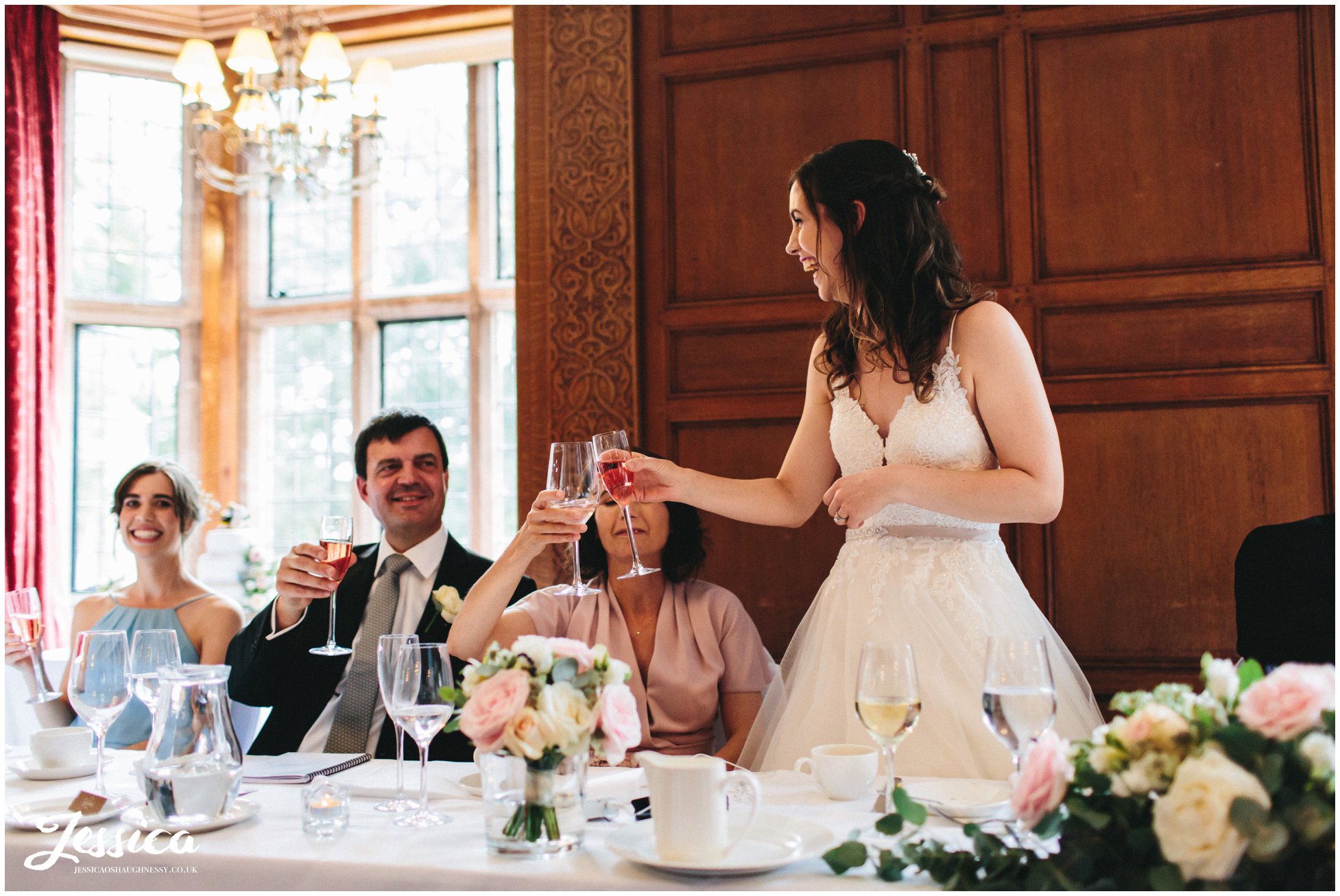 the bride cheers with her family to toast the speakers