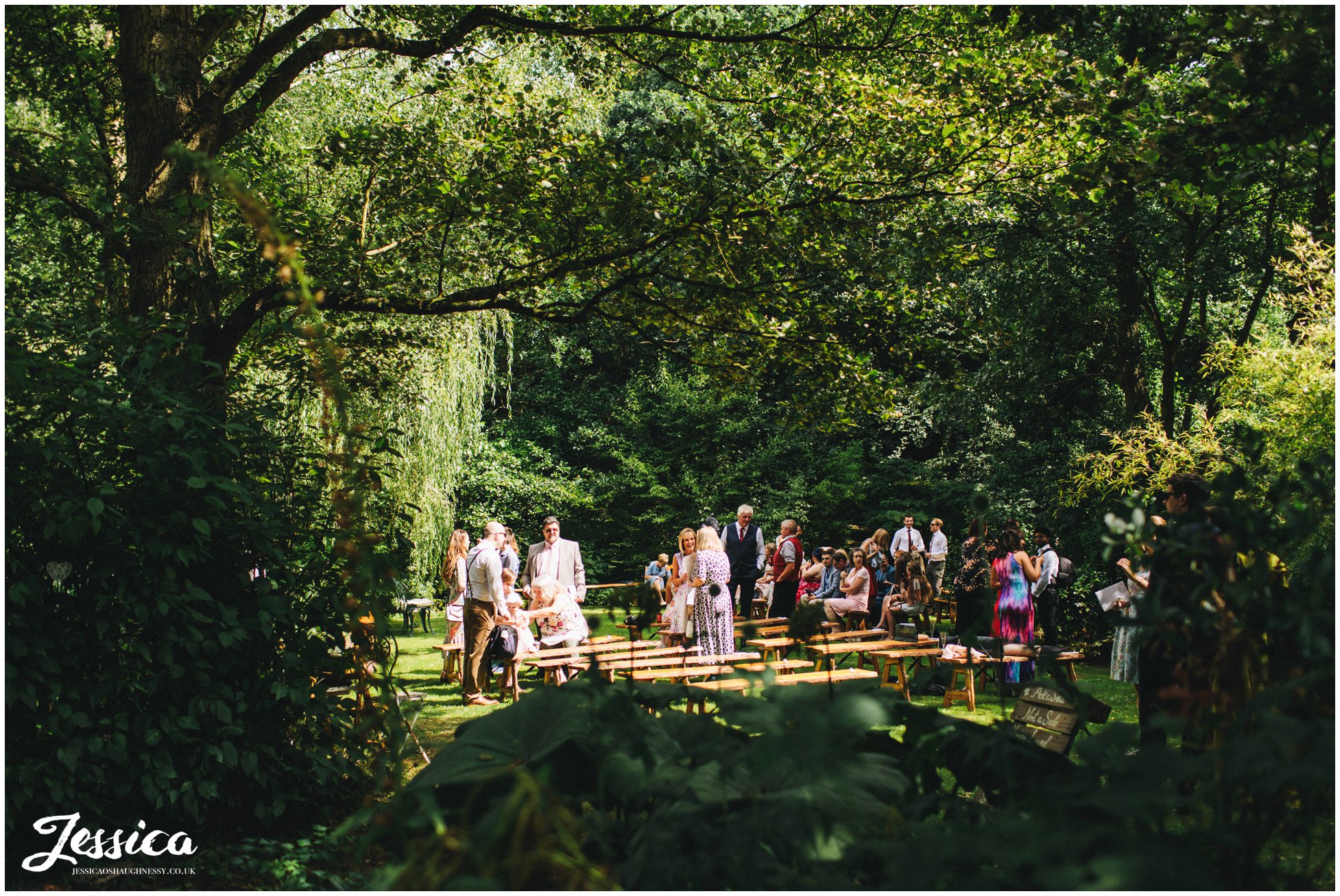 guests take their seats for an outdoor ceremony at stonyford cottage gardens