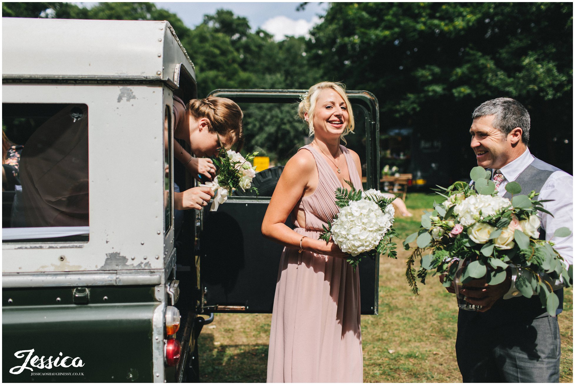 bridesmaids pile out the back of the jeep