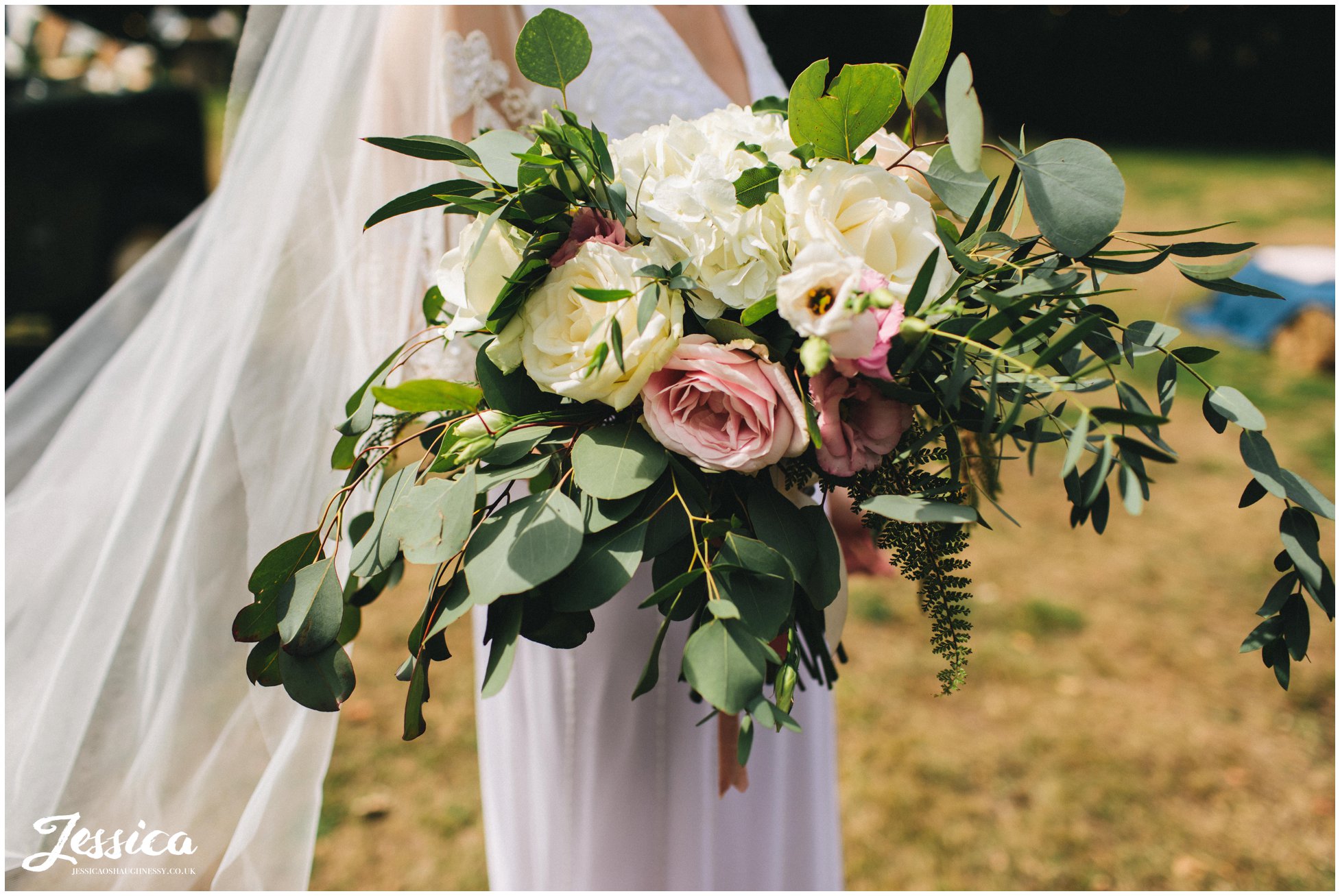 the bride holds her boho bouquet