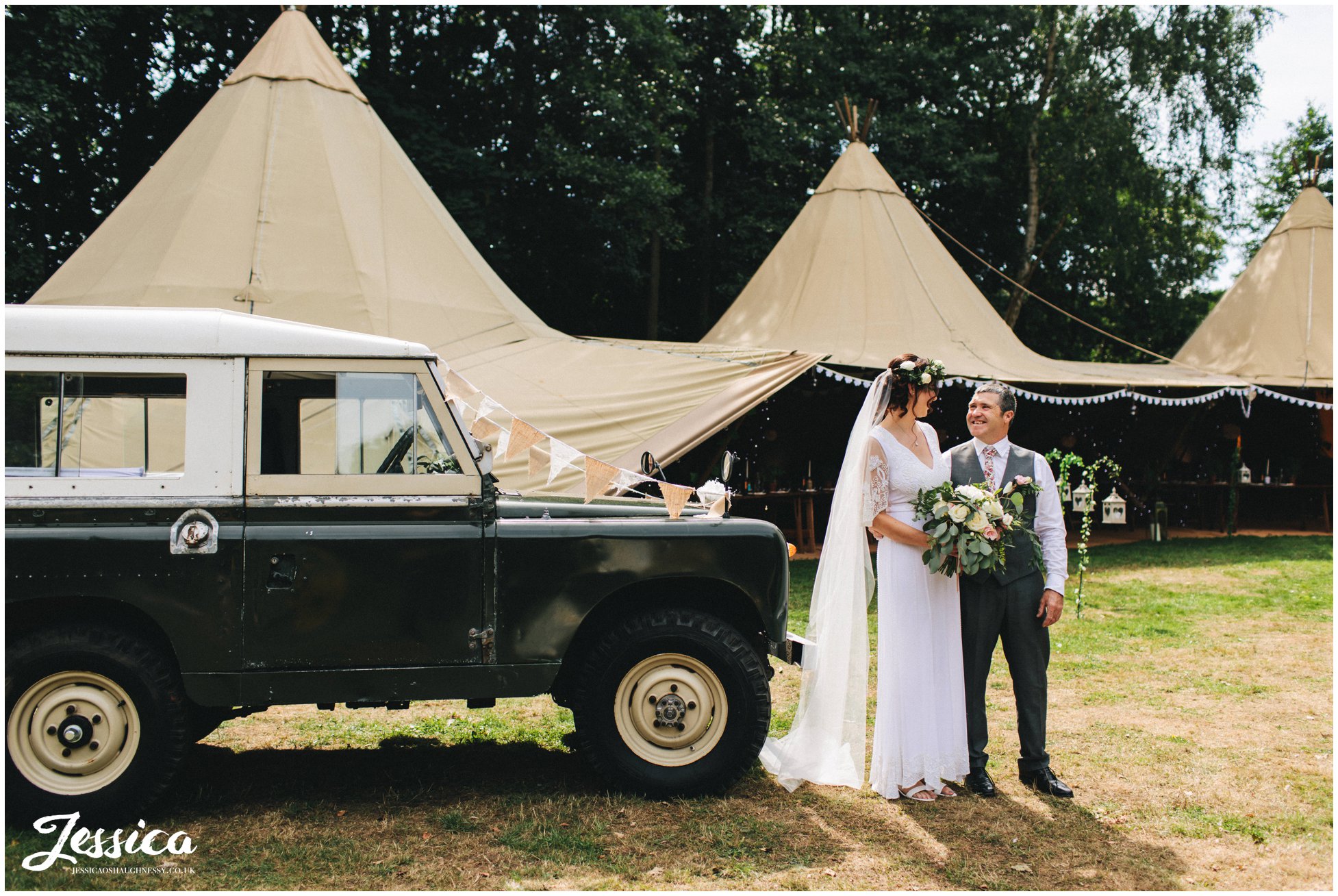 the bride & her father stand in front of the tipi