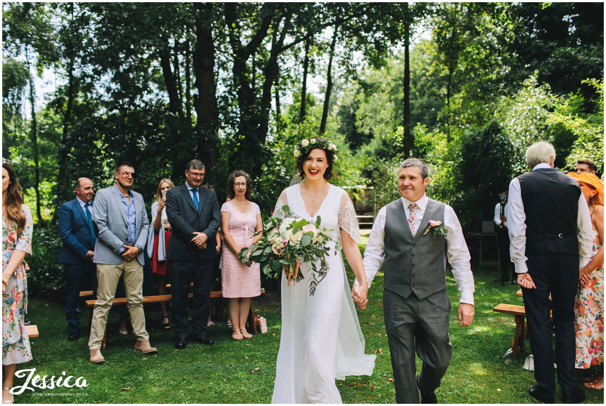 bride walks down the aisle with her dad