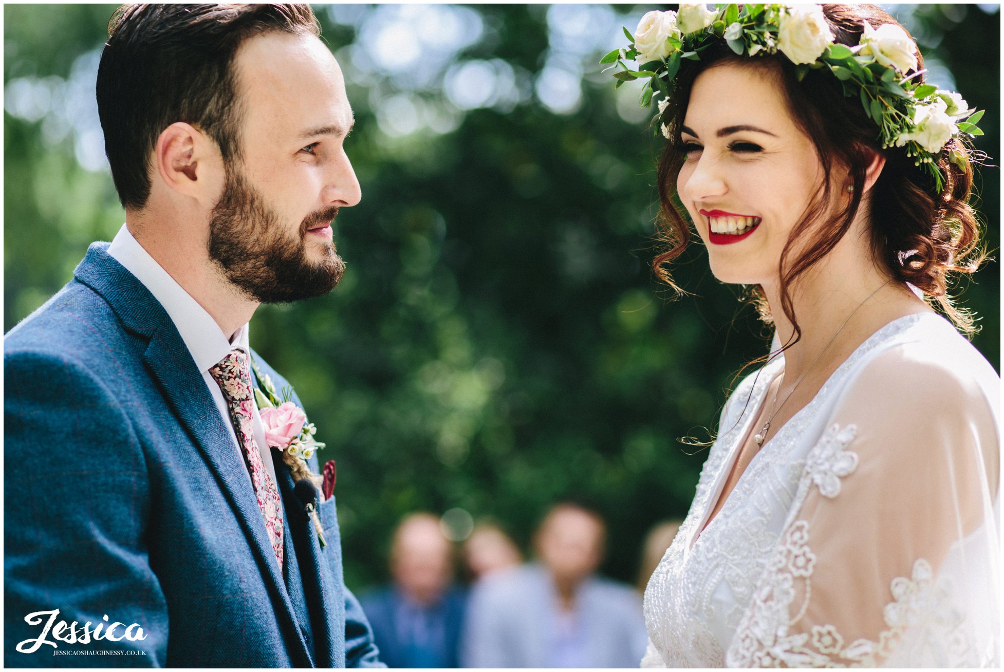 the groom admires the bride as she smiles