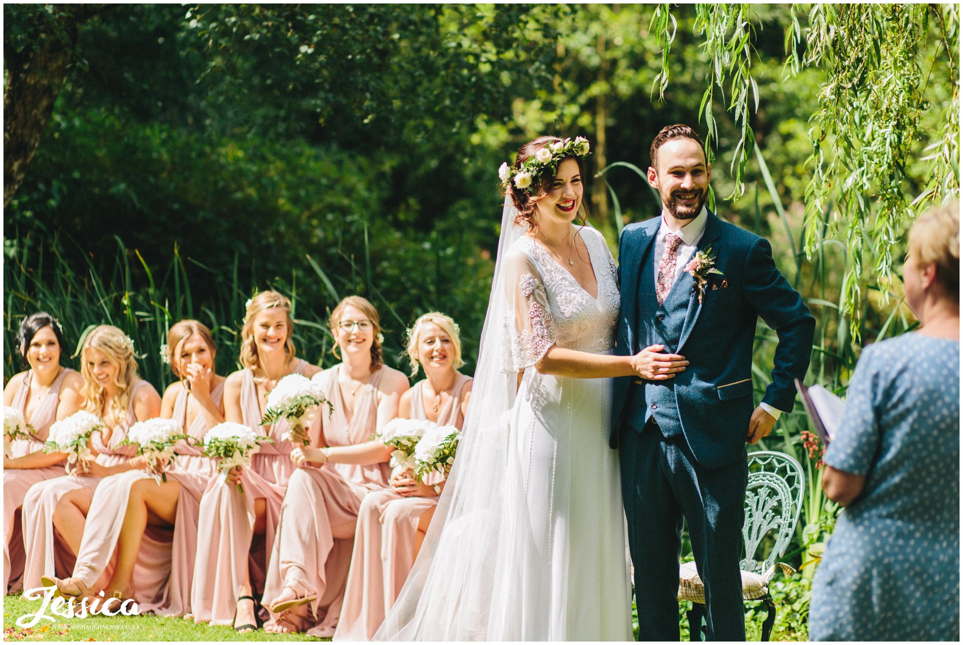 the couple hold each other during the service at stonyford cottage gardens