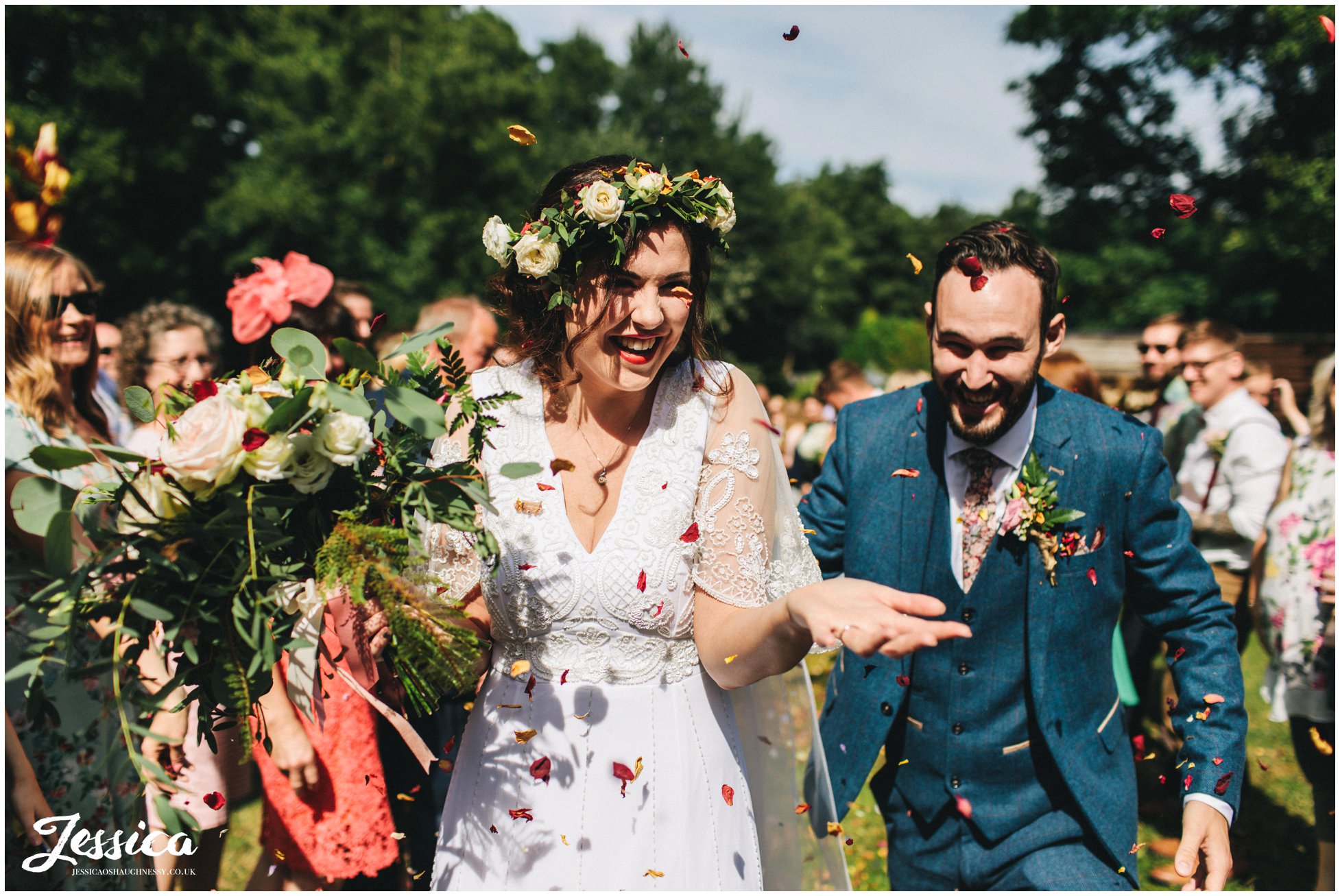 the couple are showered with dried rose petals