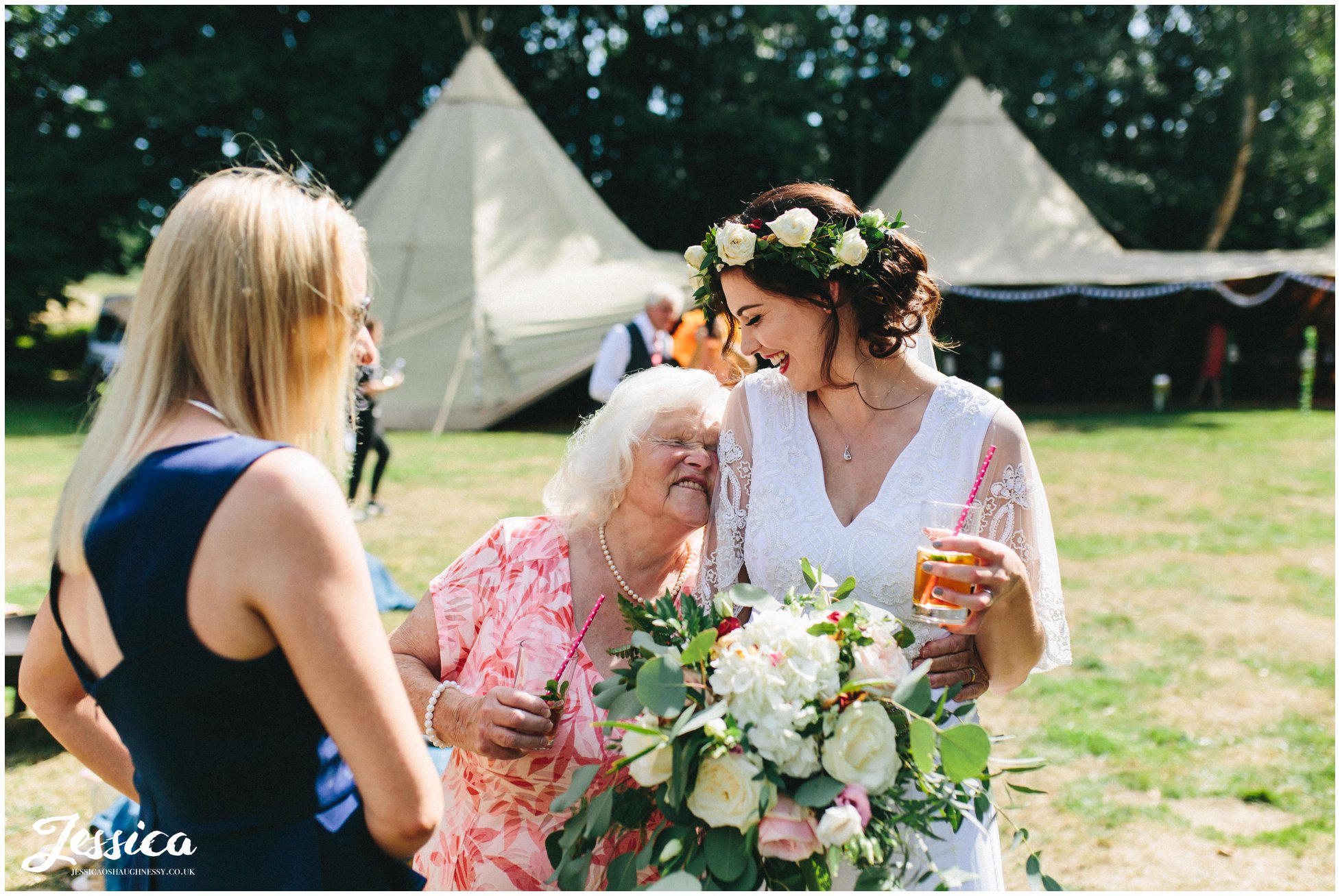 the bride hugs her grandma at the tipi wedding