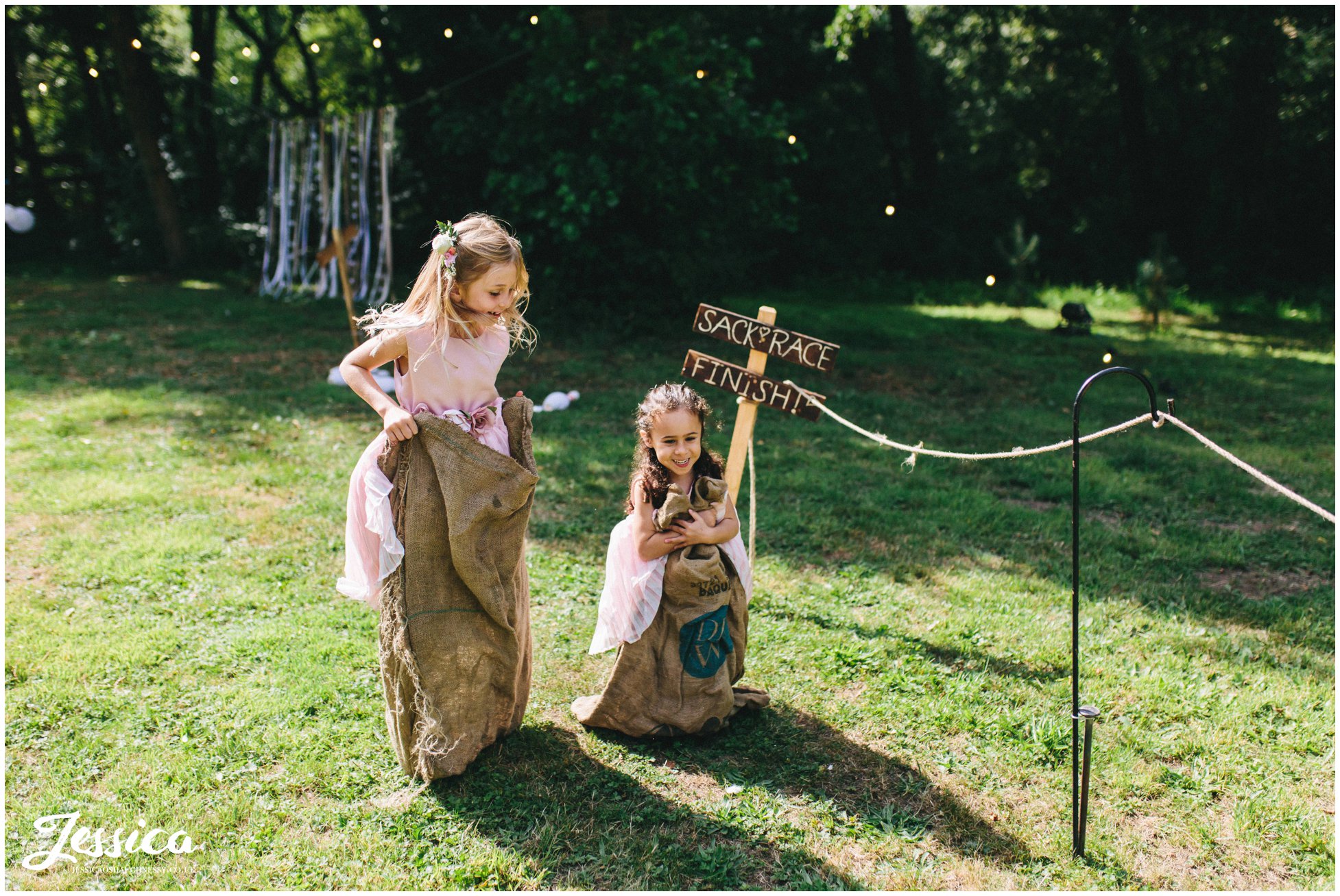 flower girls play in hessian sacks