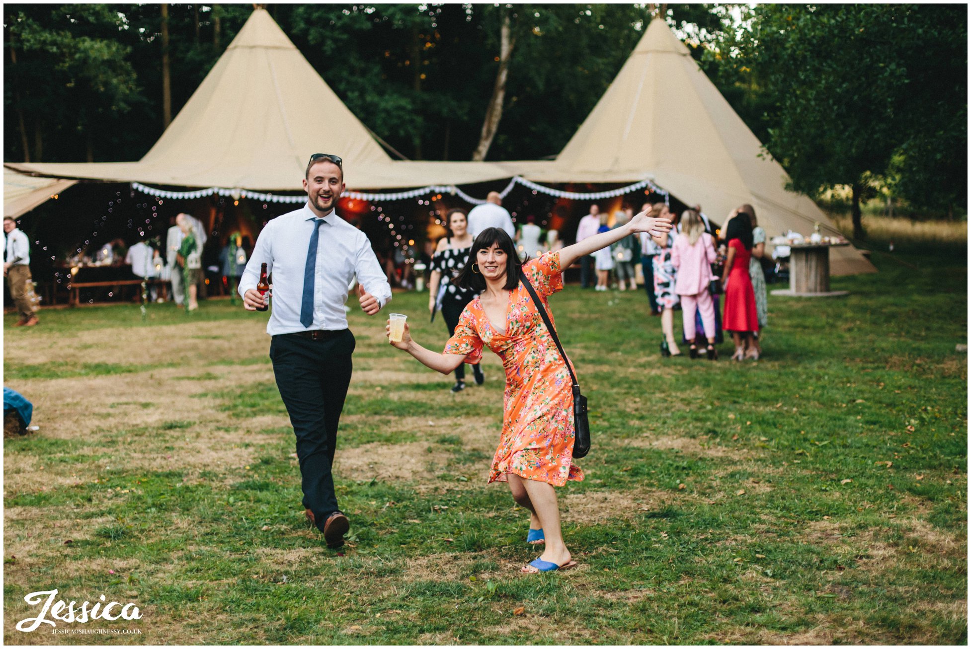 guests pose for the camera in front of the tipi