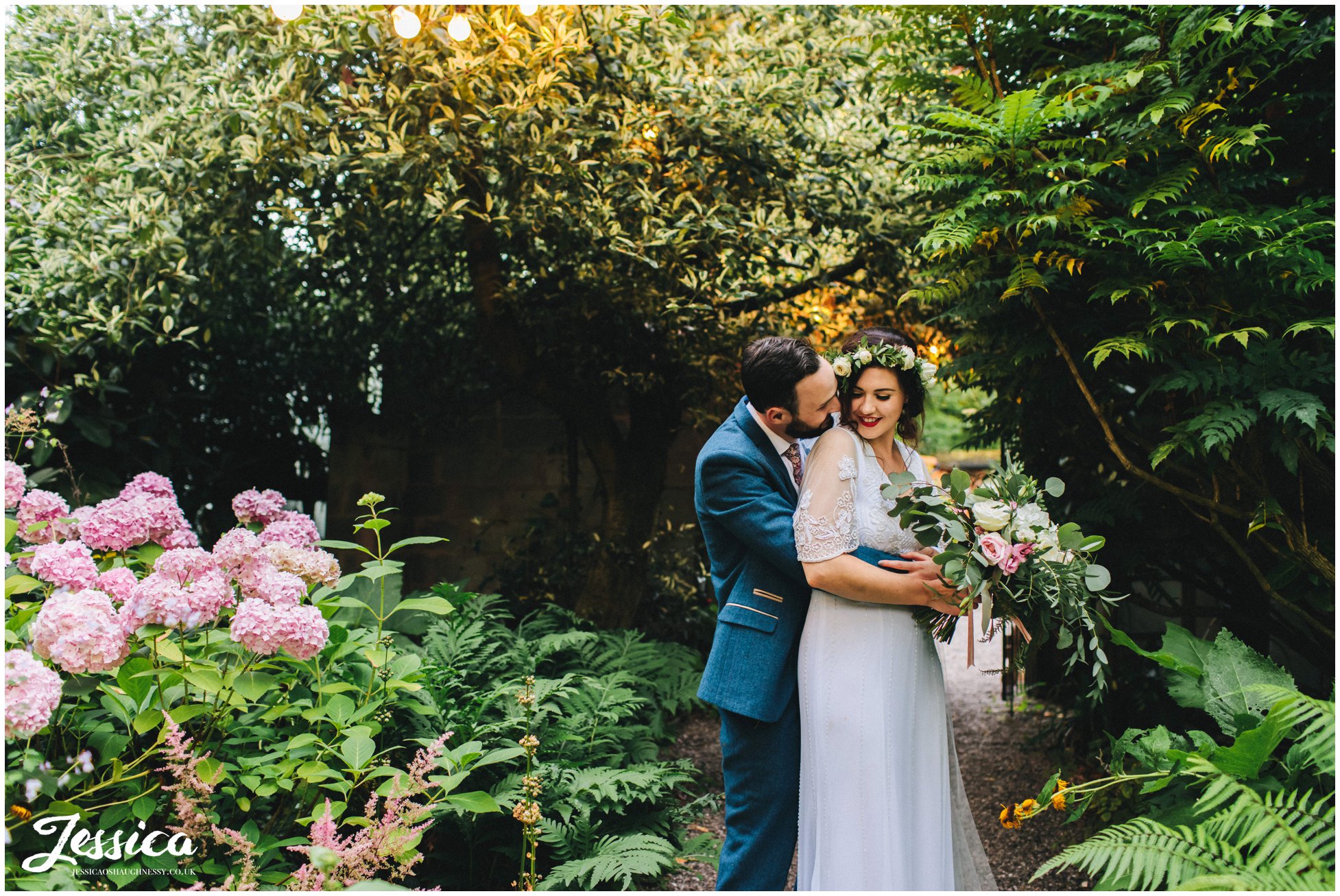 the couple hug in the gardens in cheshire