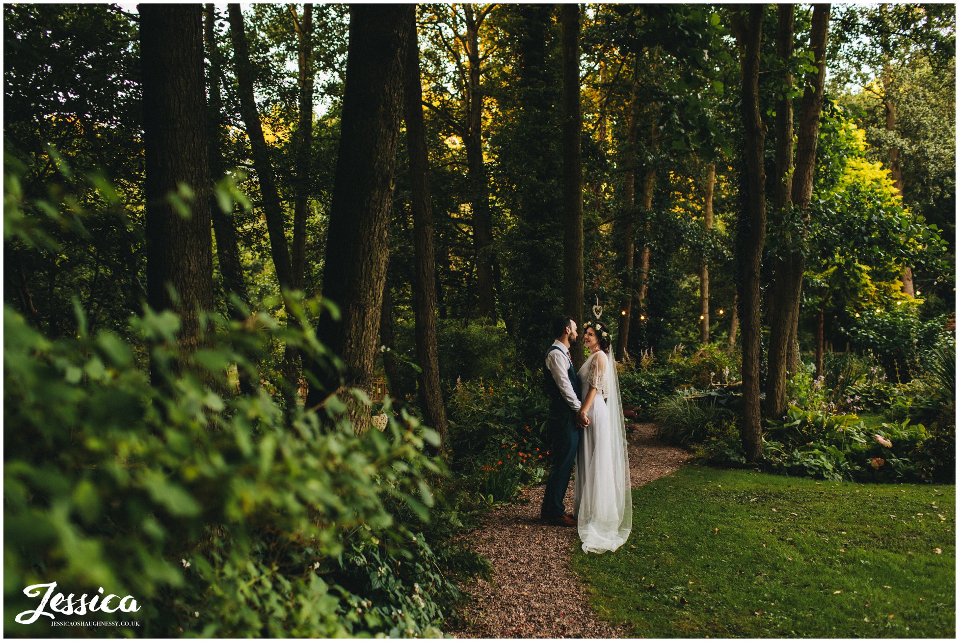 newly wed's hold hands at their woodland wedding in cheshire