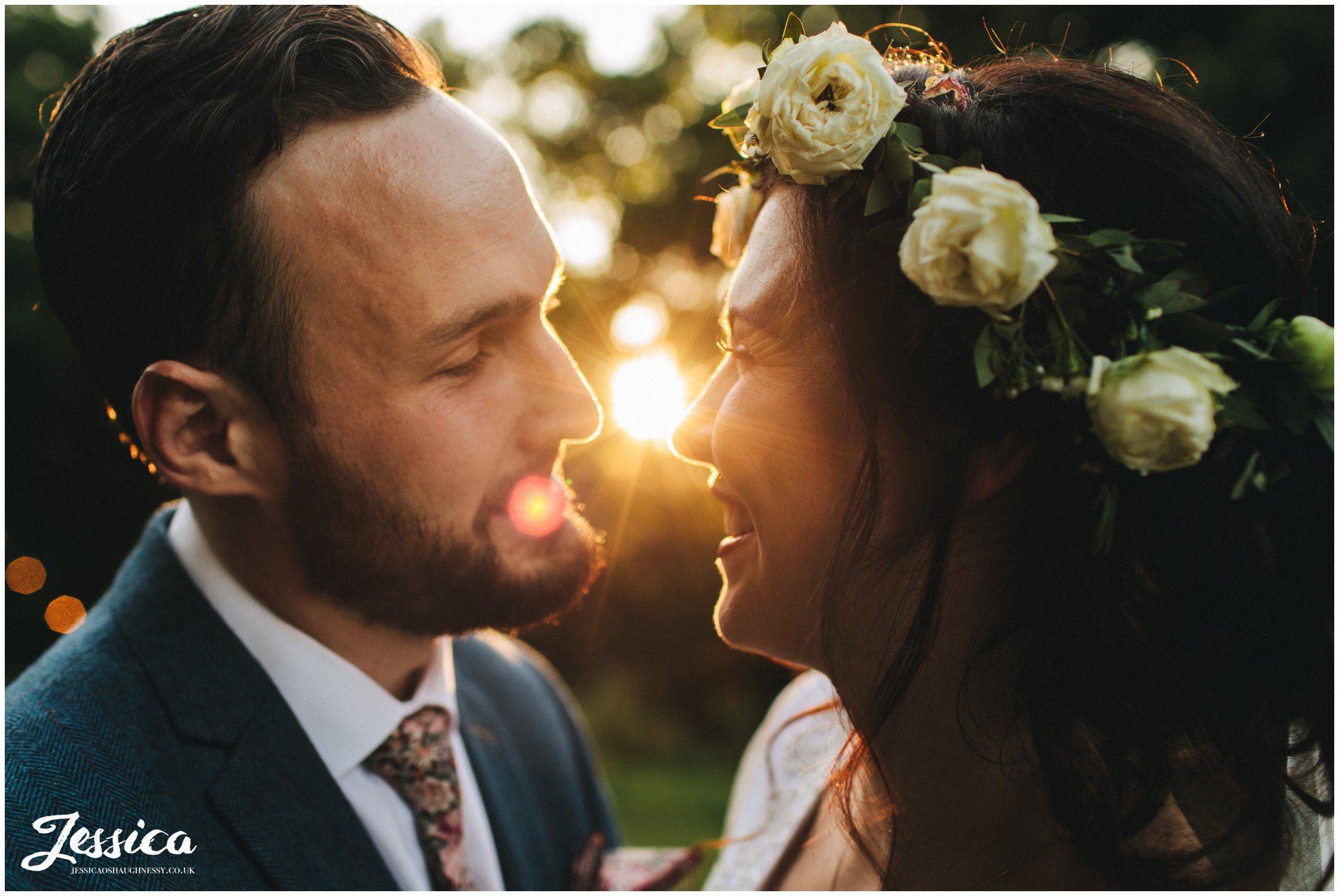 couple kiss as the sun sets during their boho tipi wedding