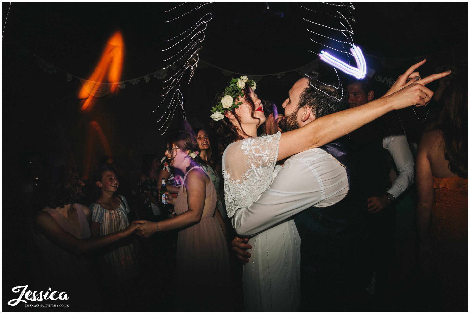 husband and wife dance together to their wedding band