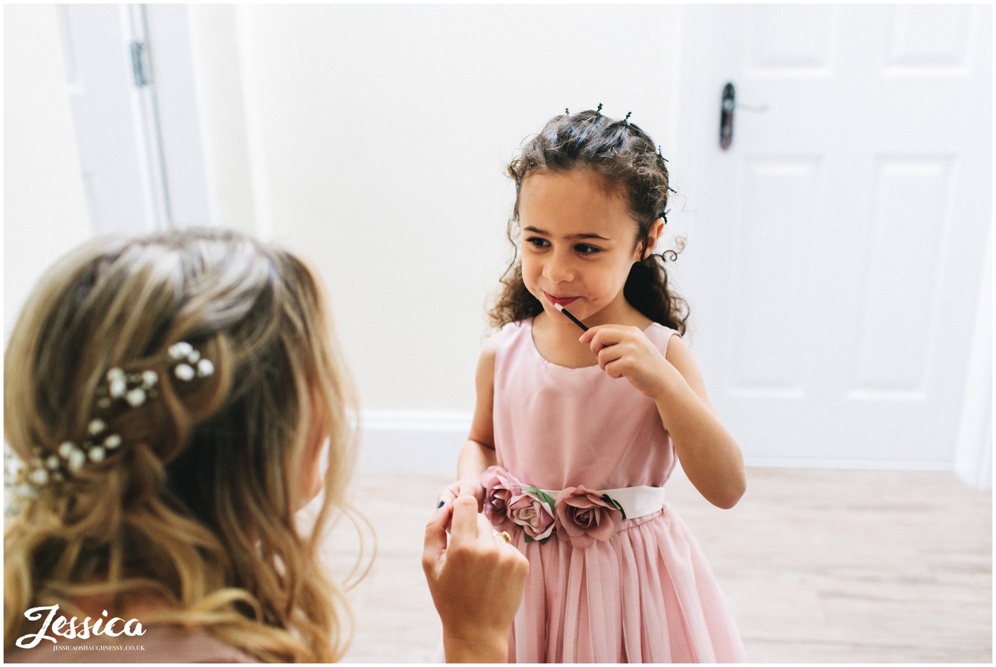 flower girl puts on lip gloss 