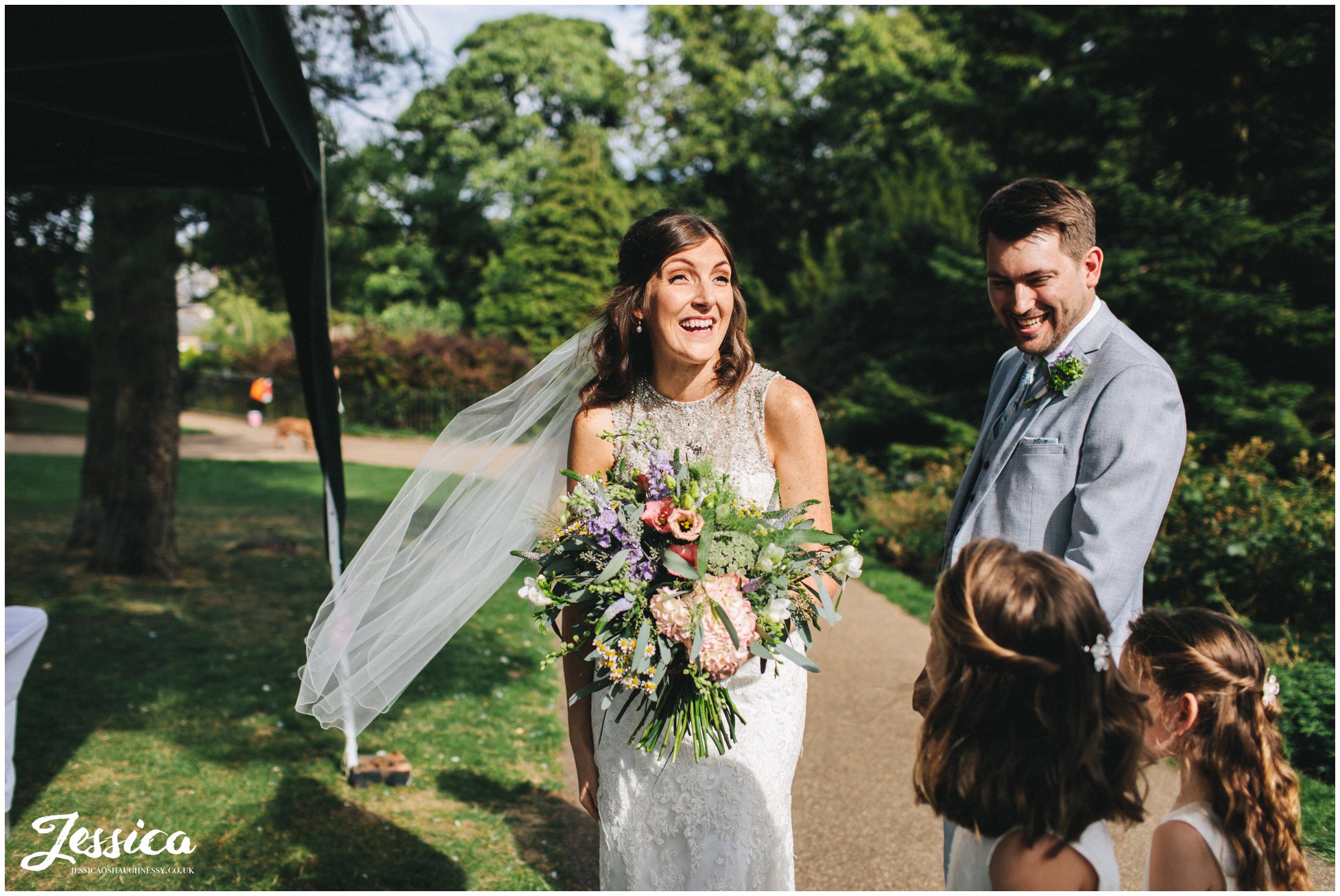 bride laughs excitedly at buxton pavilion gardens