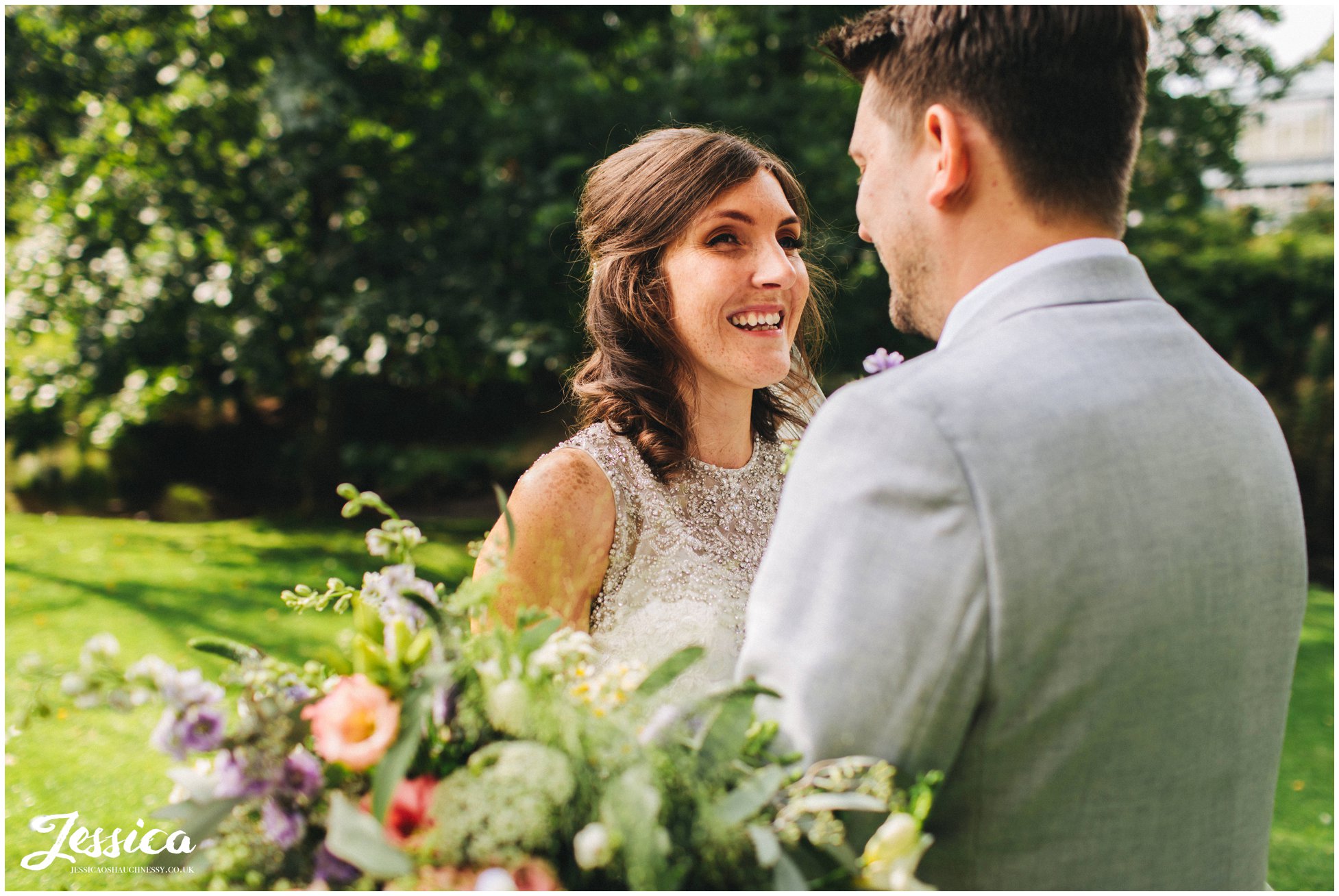 bride smiles at her groom on their derbyshire wedding day