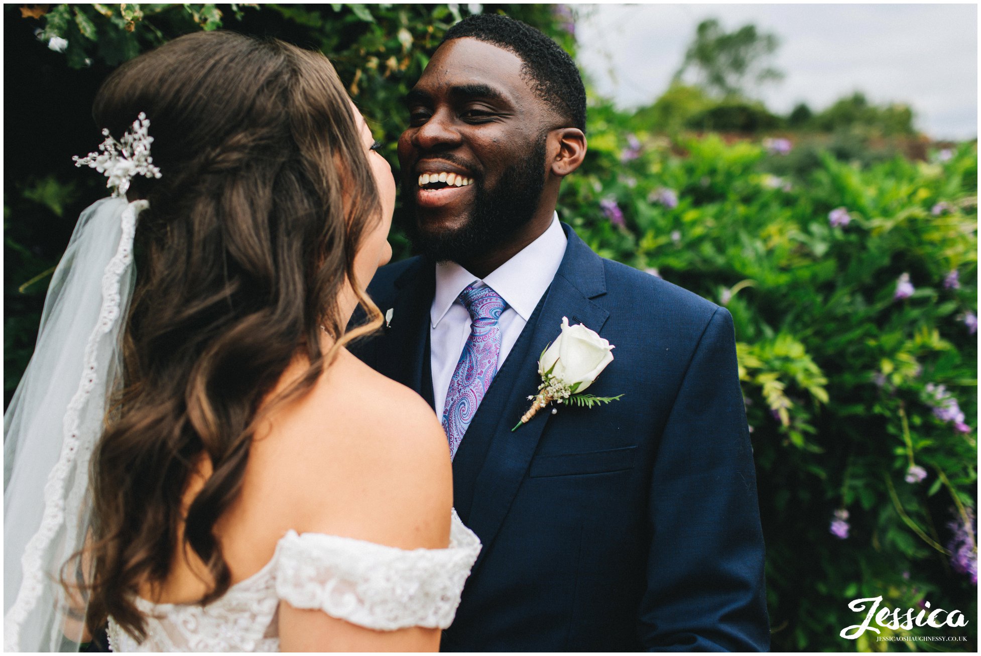 the groom laughs as he speaks to his new wife