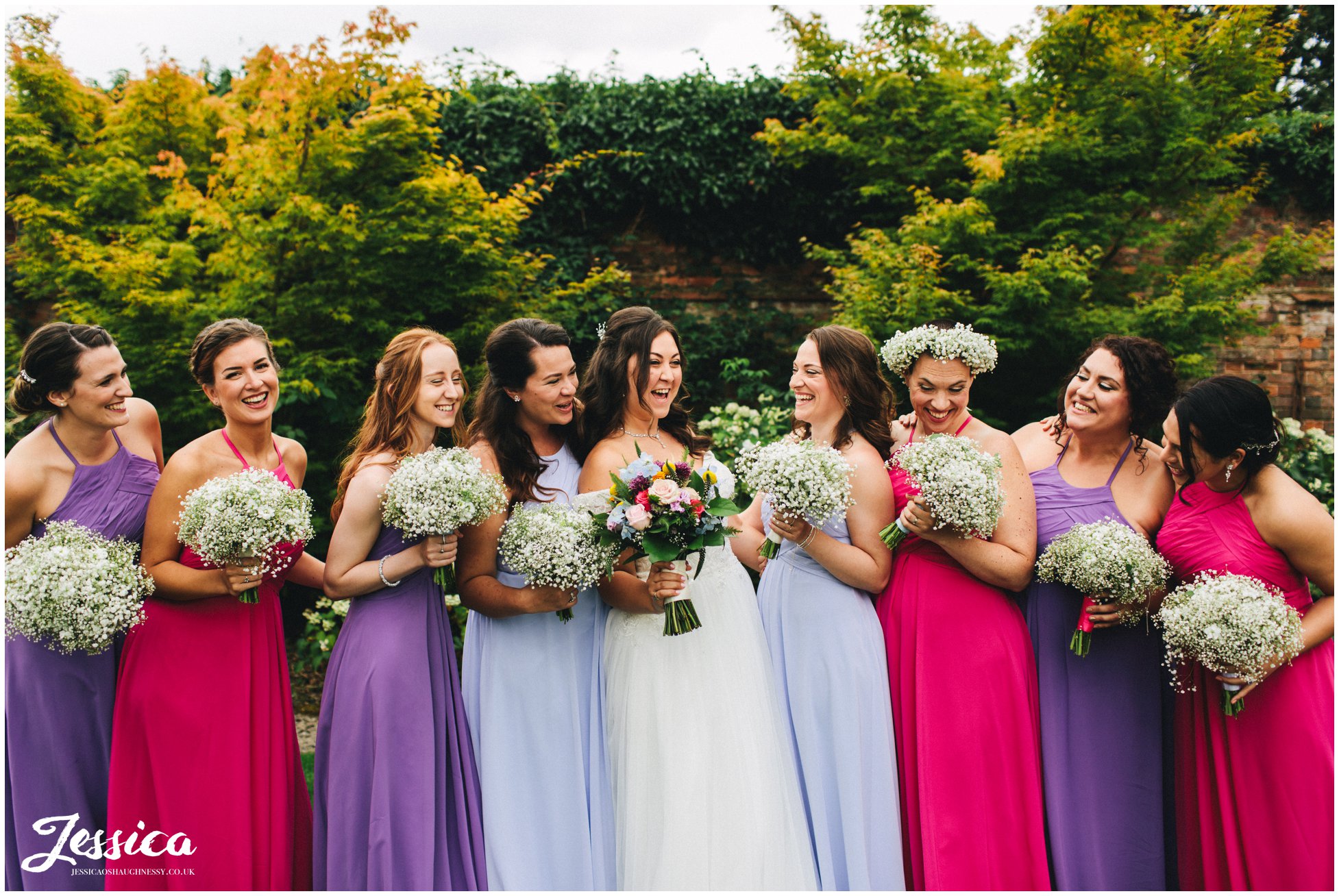 the bride laughs with her bridesmaids