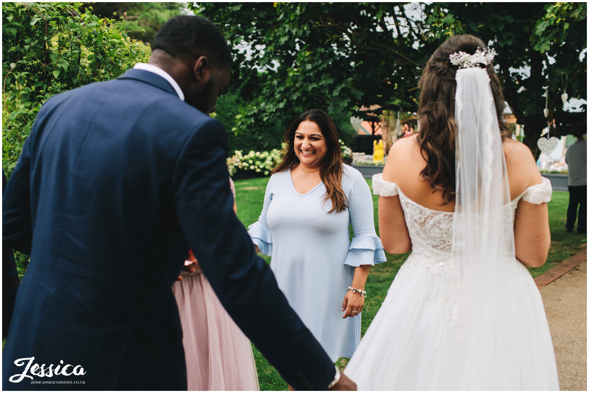 wedding guests speak to the couple during their drinks reception