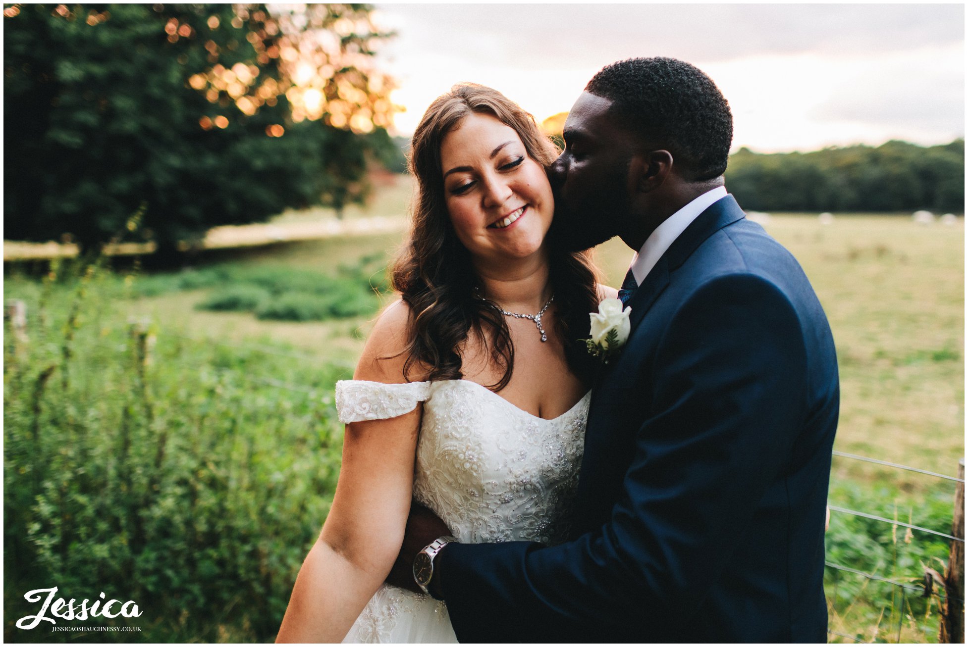 the groom kisses the brides cheek at gaynes park in epping