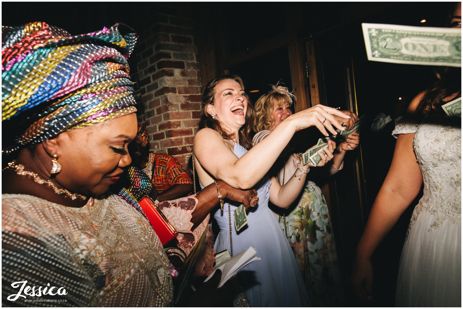 wedding guests throw dollars over the new couple