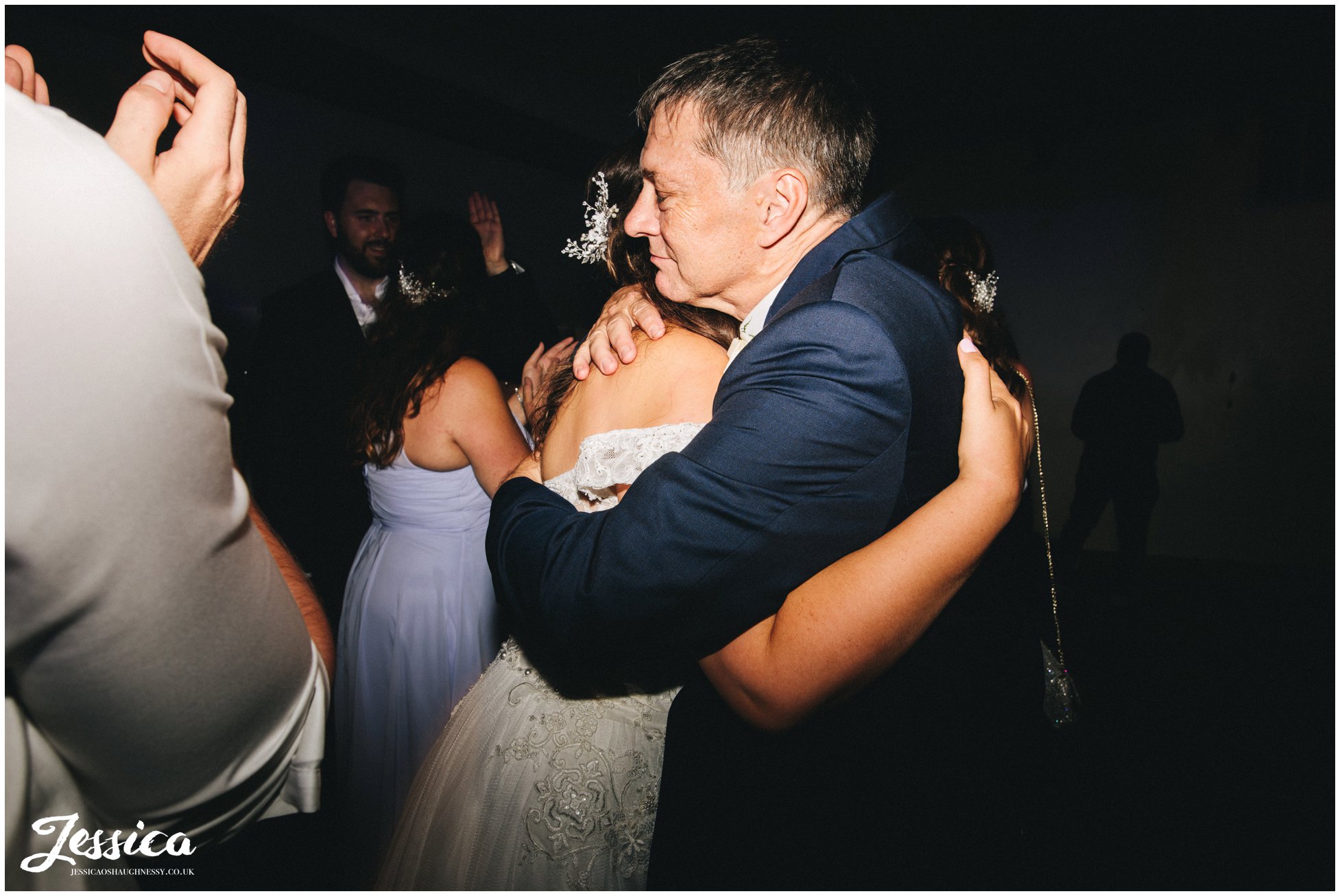 the bride hugs her father on the dancefloor at gaynes park