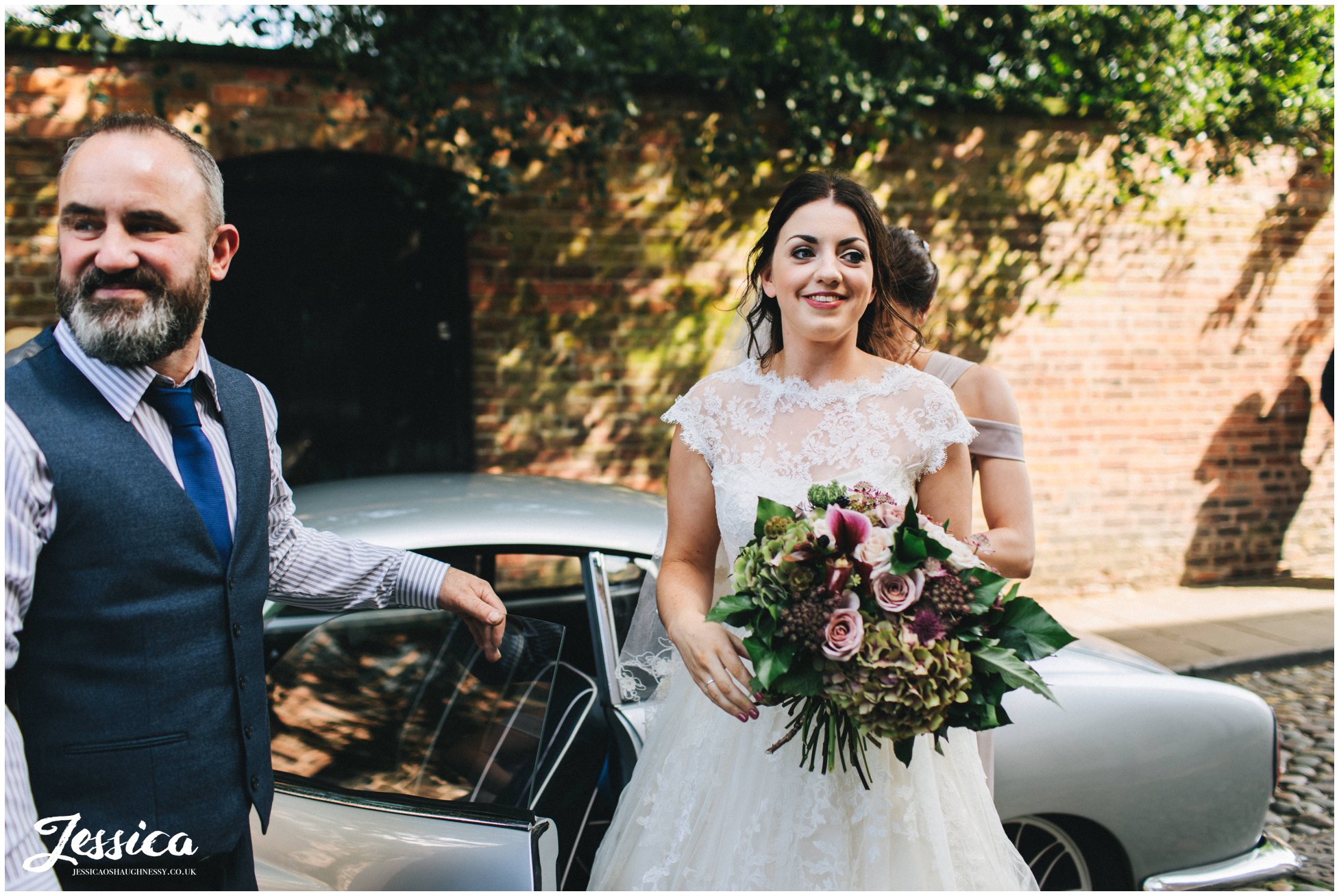 bride gets out of the car and heads to the church