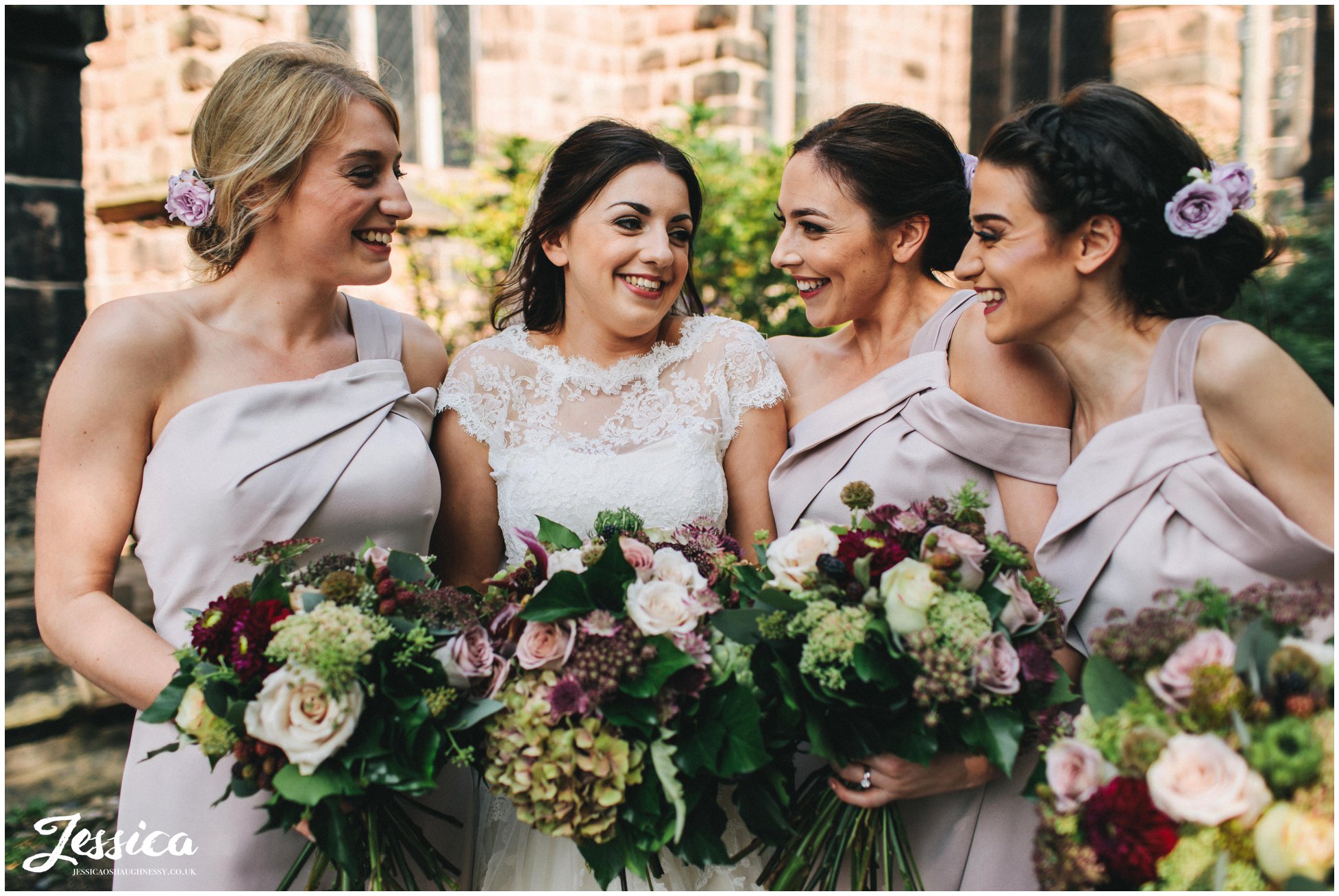 bride and bridesmaids laugh together before the ceremony