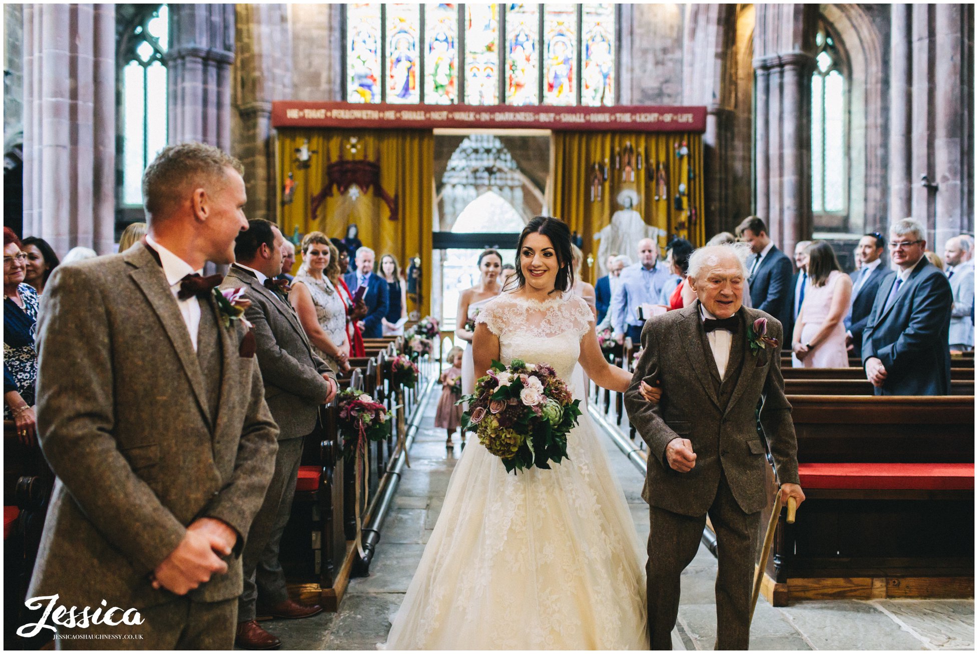bride walks down the aisle with her grandfather