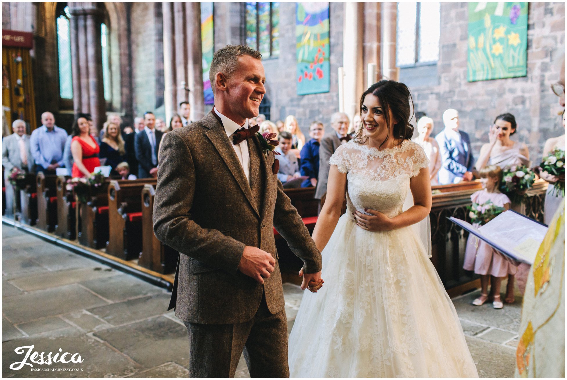 bride & groom smile at each other during their service