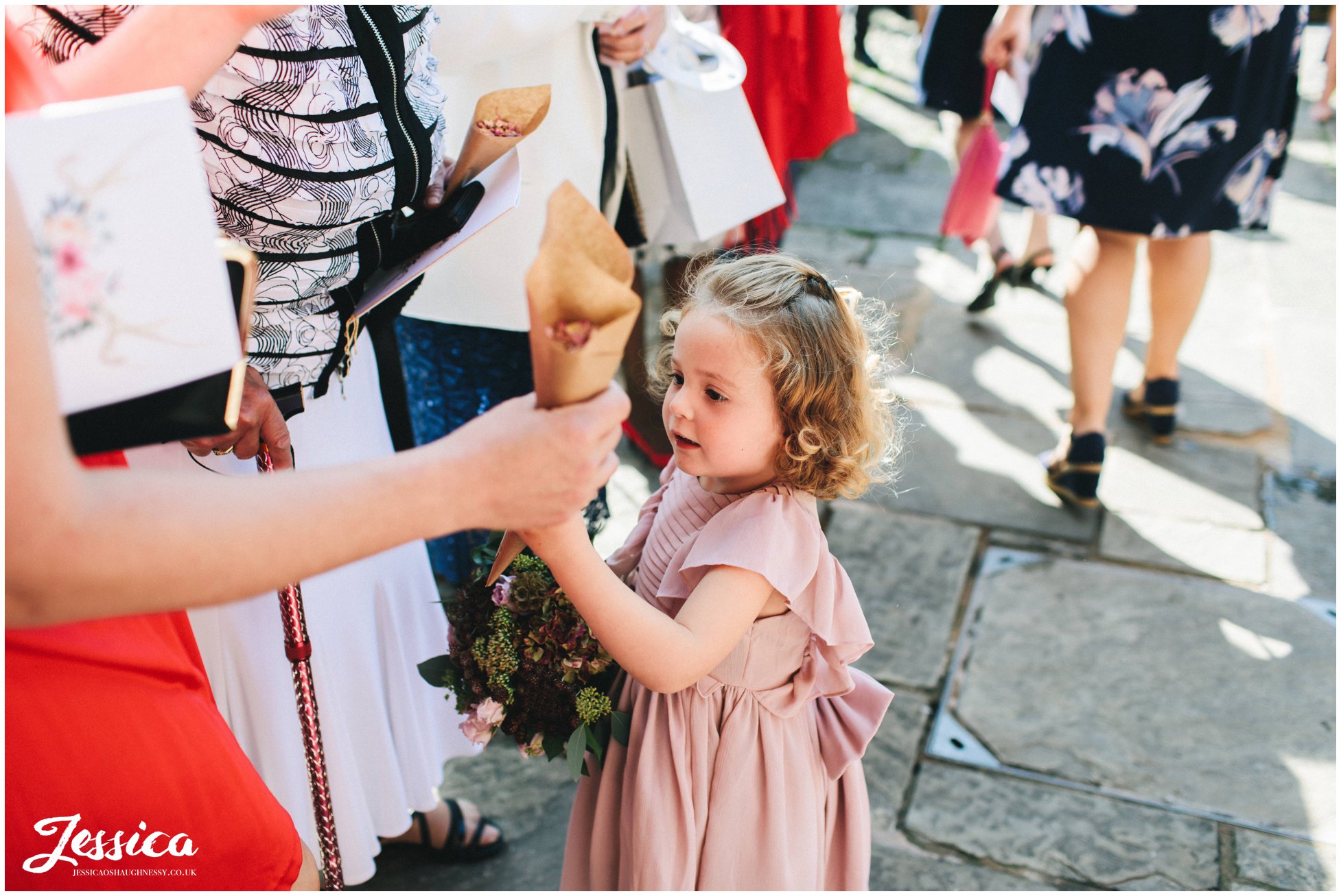 flower girl takes confetti