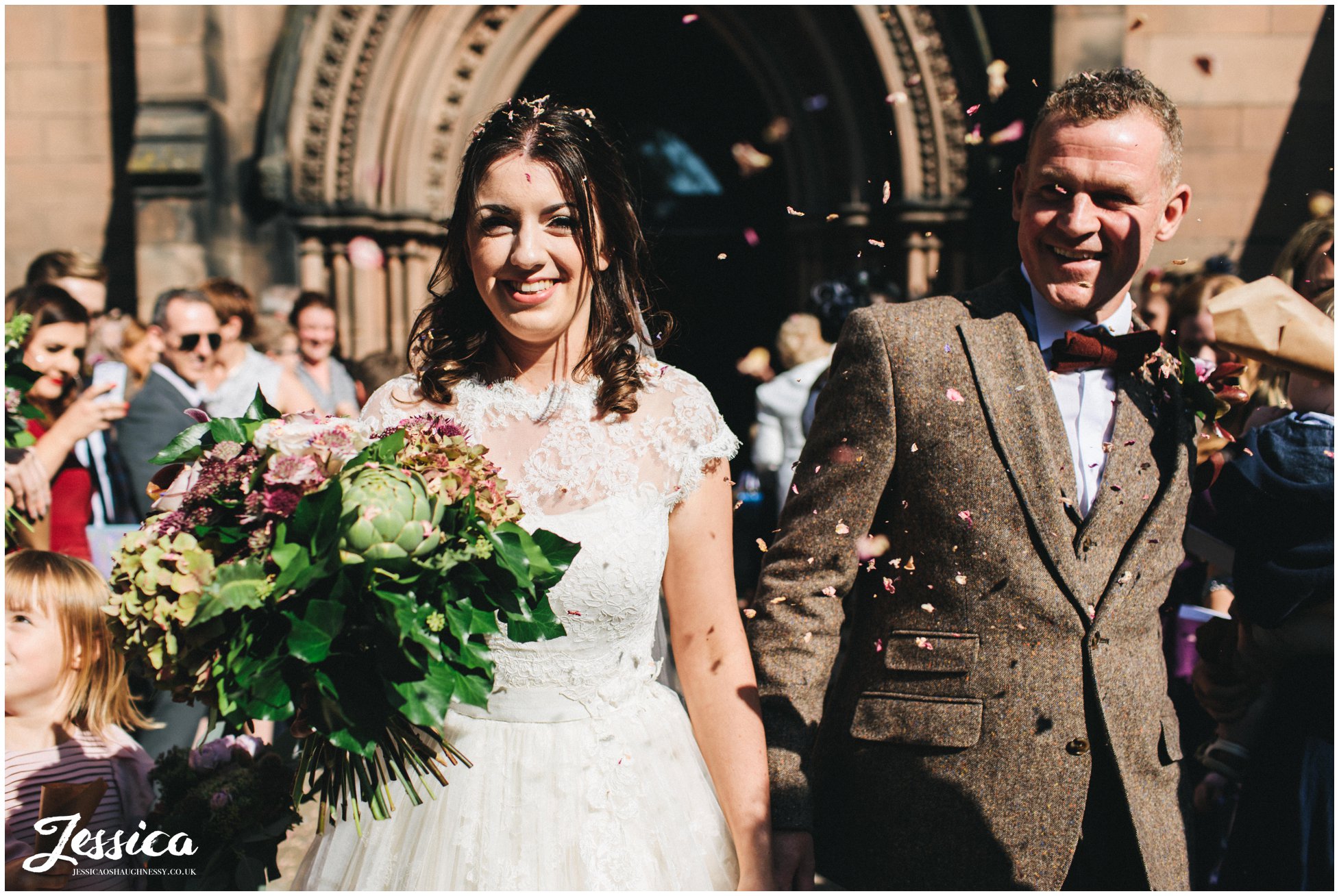 guests shower the couple with confetti at st mary's in nantwich