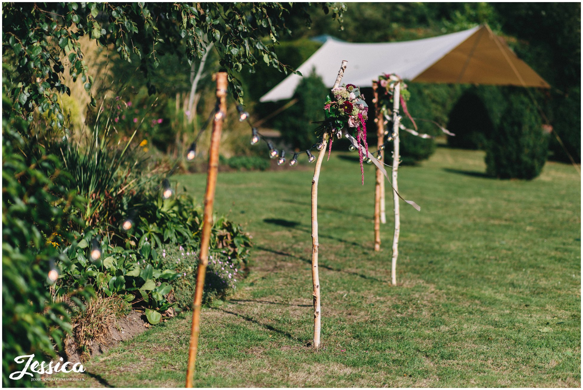 flowers & festival lighting decorate the wedding reception