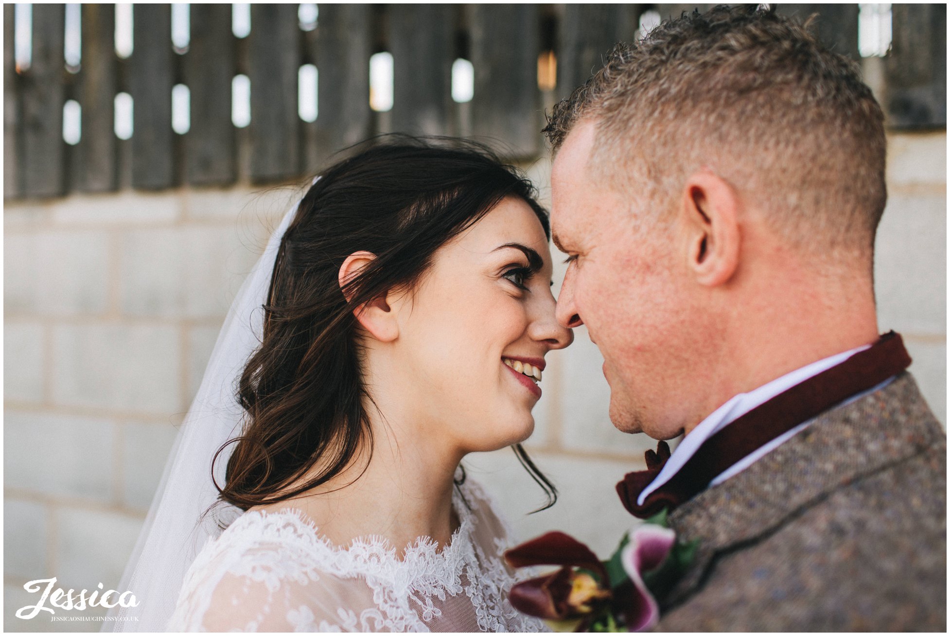 couple kiss in the farm in cheshire on their wedding day