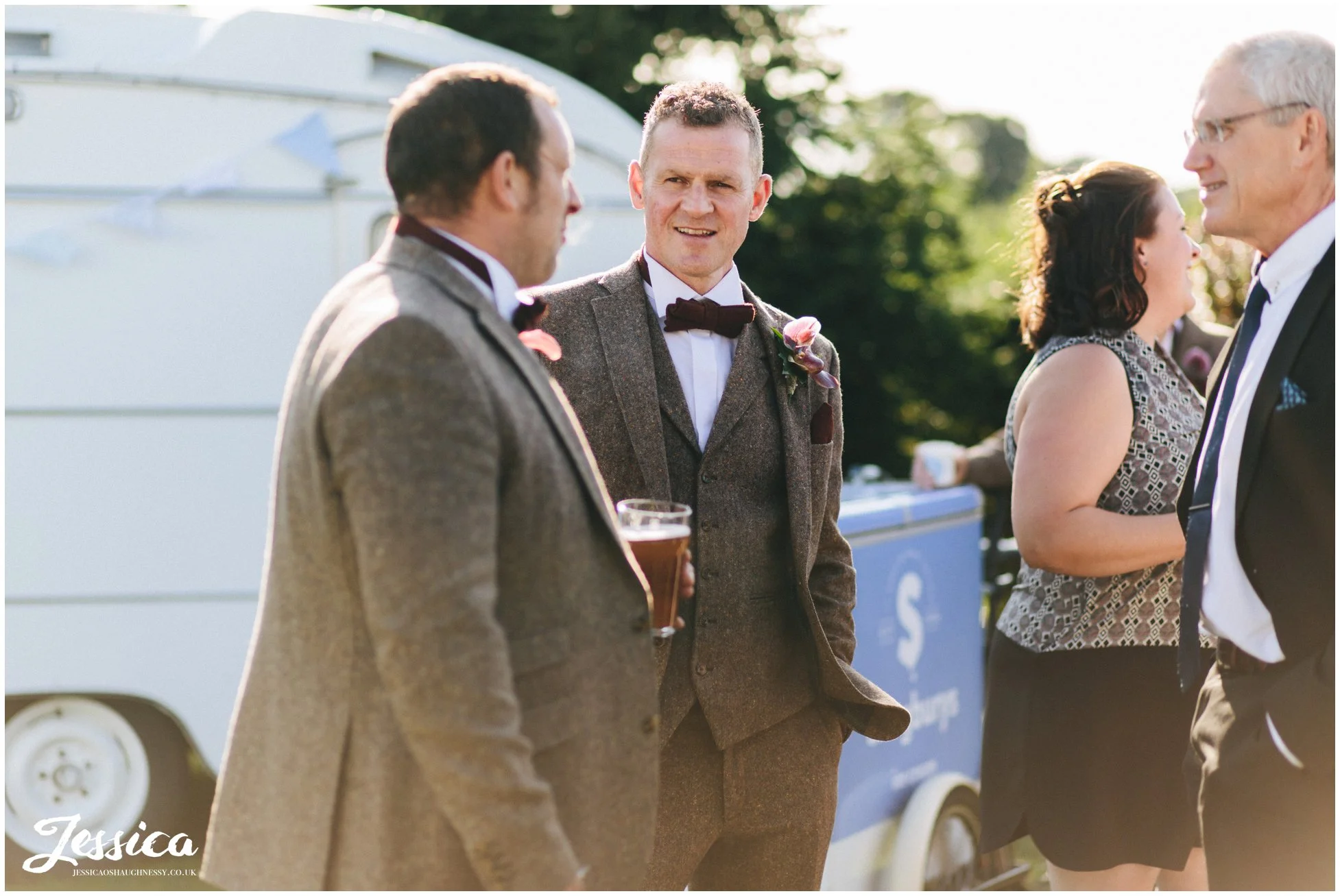the groom laughs with his friends