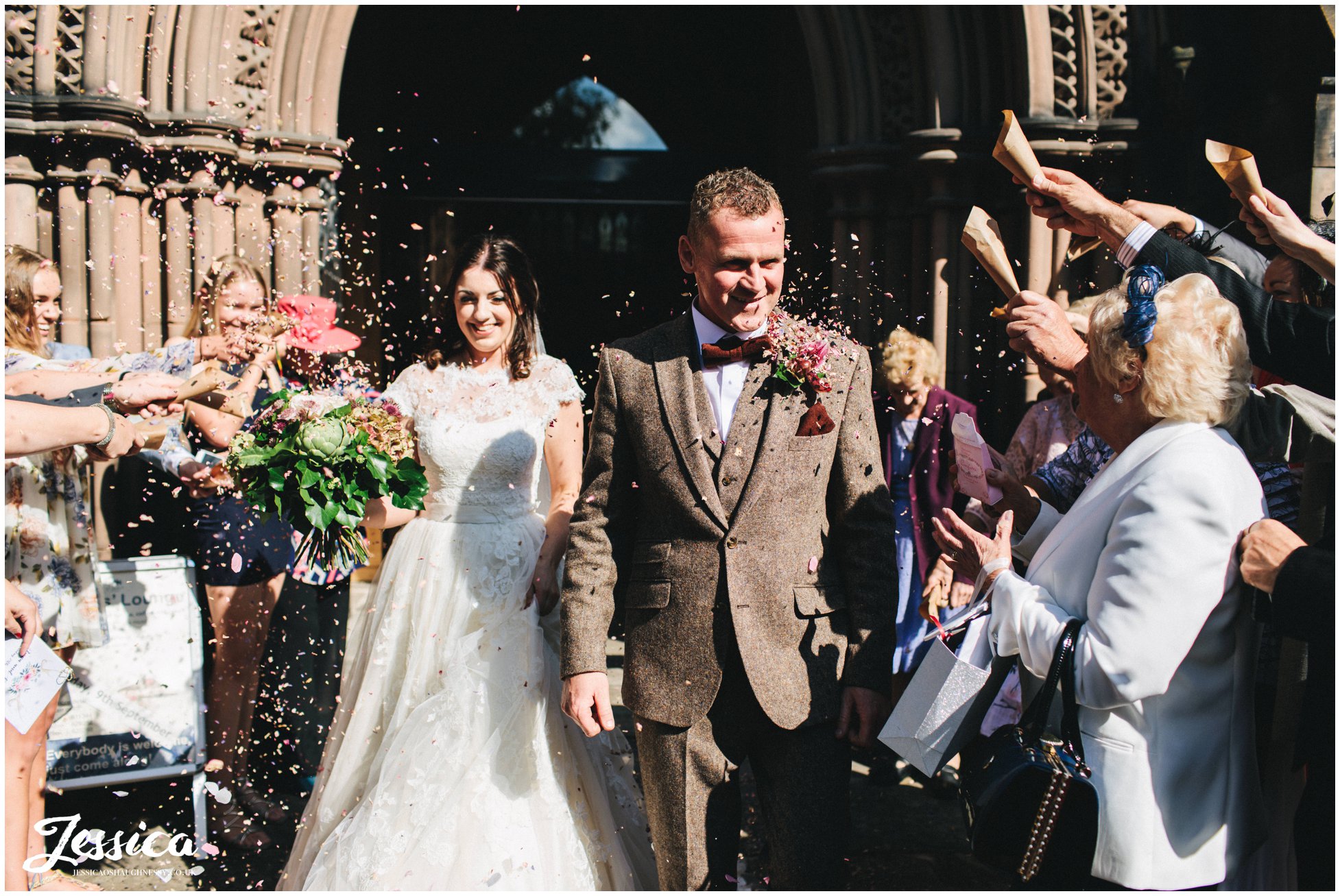 couple walk through their confetti line