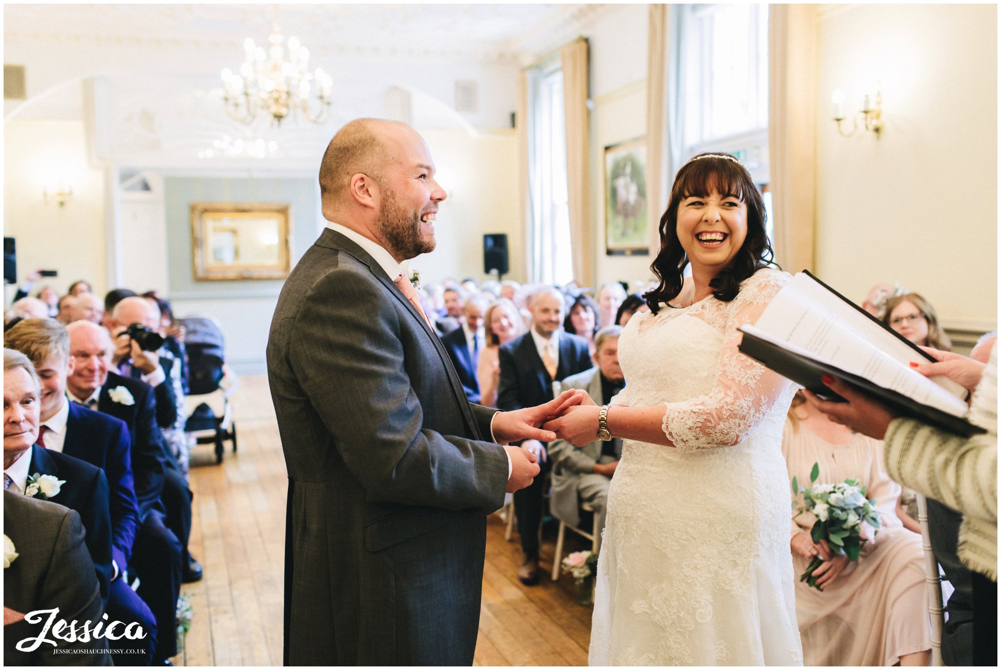 the couple laugh during their wedding ceremony at nunsmere hall