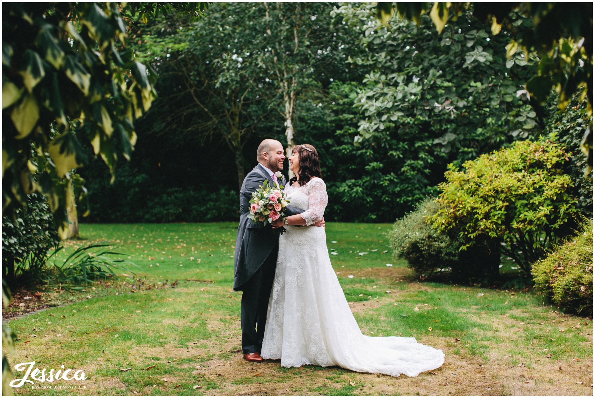 the newly wed's kiss in the gardens at nunsmere hall