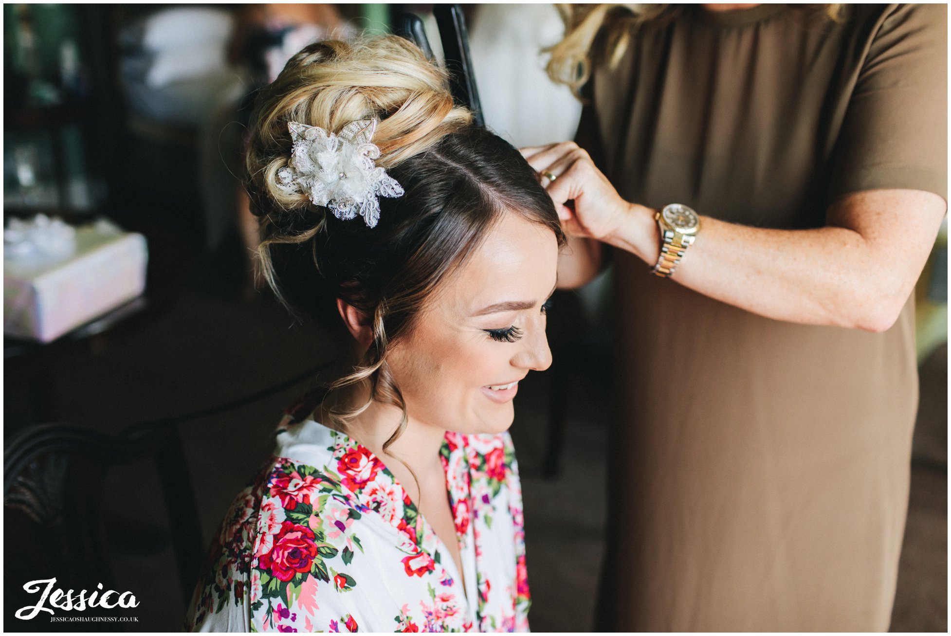 the bride has her hair done on the morning of her wedding 