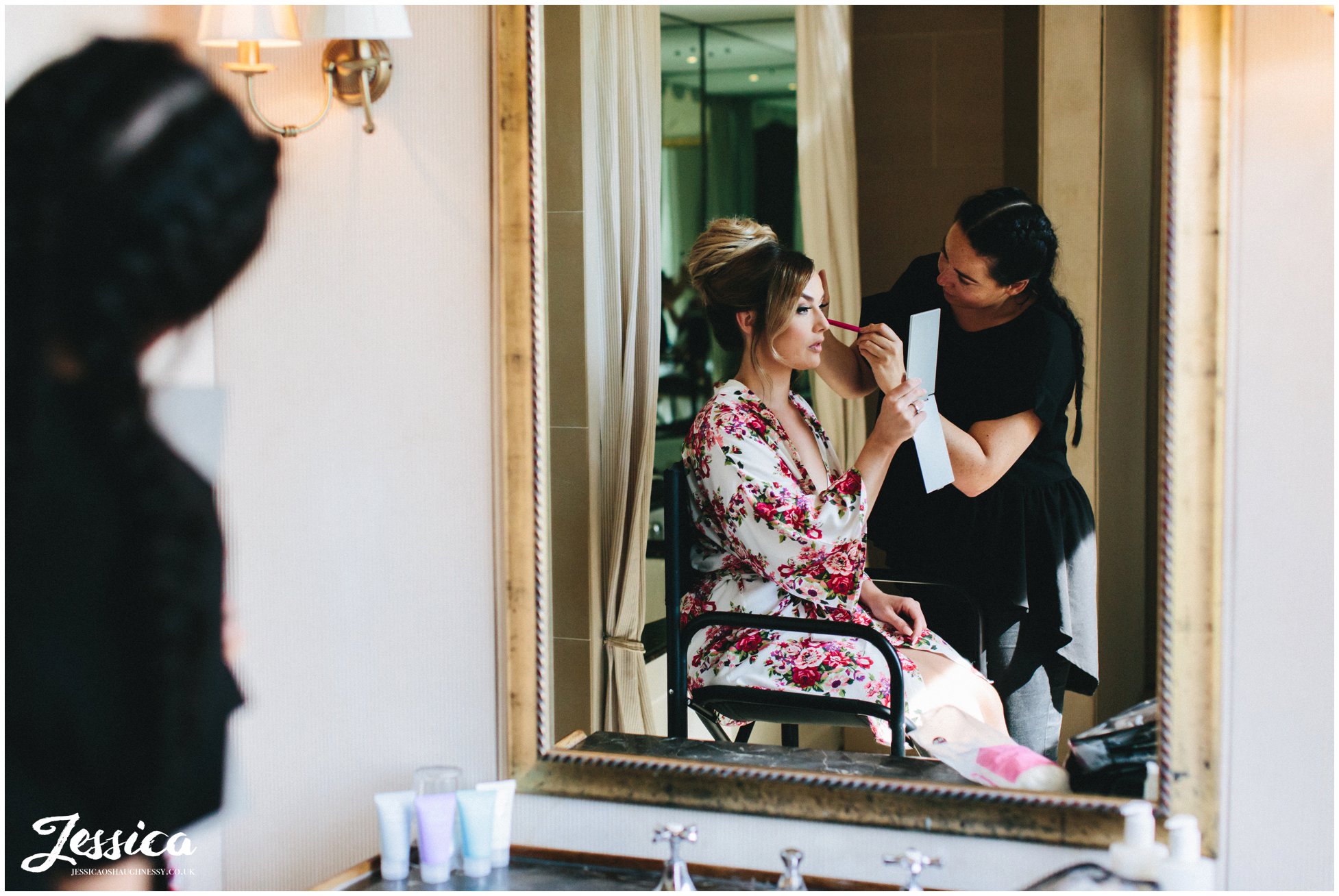 the bride has last make-up touches before the ceremony