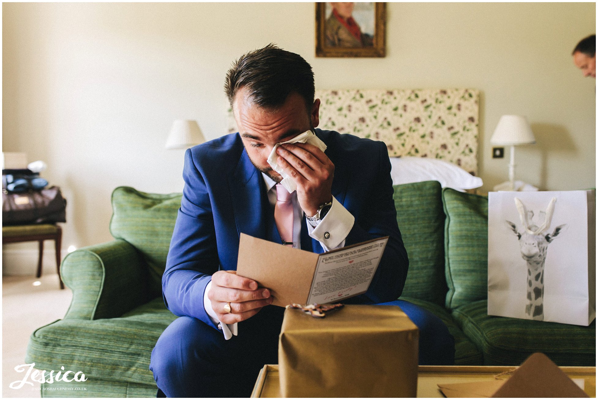the groom cries as he reads a note from the bride