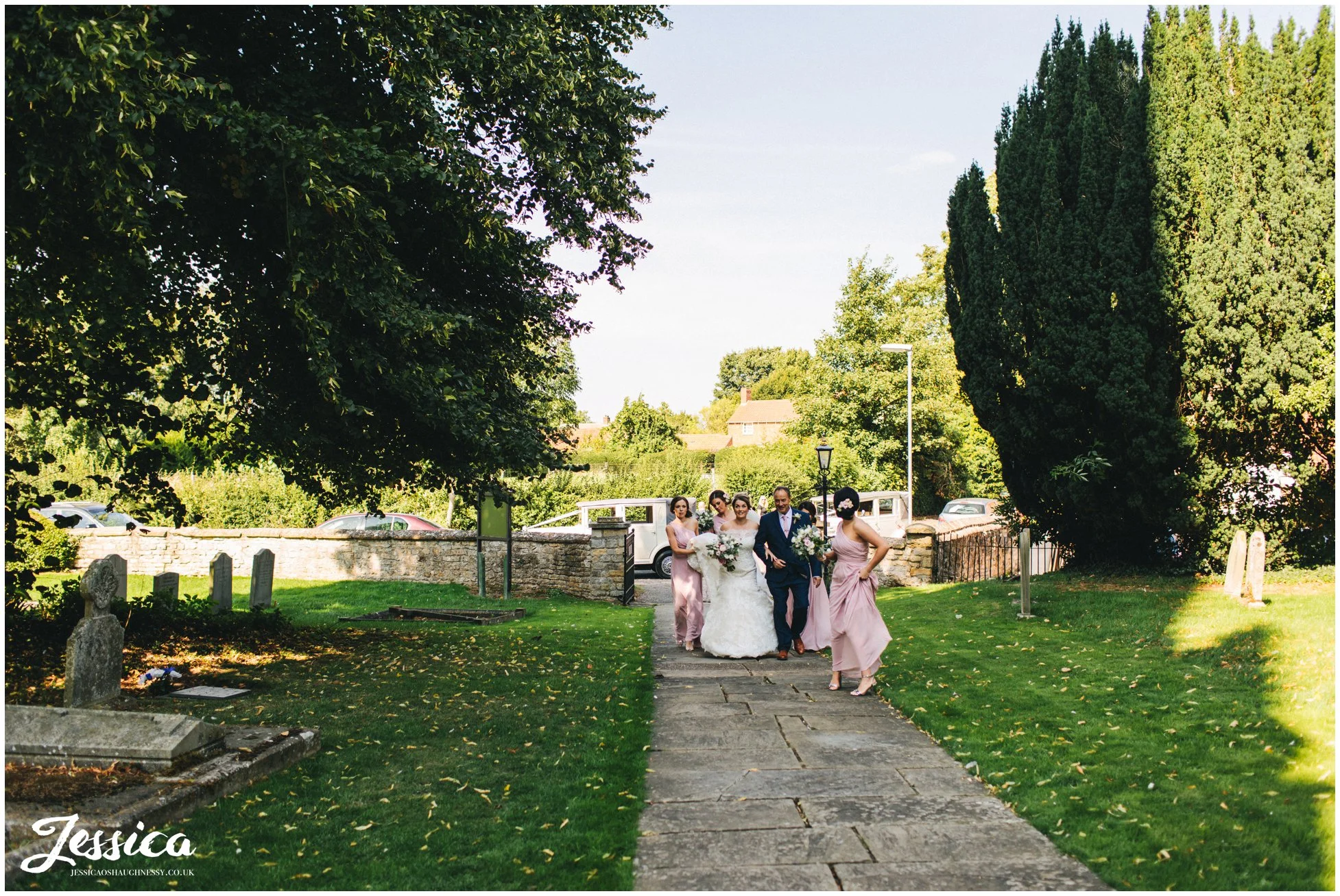 the bride walks up the church path