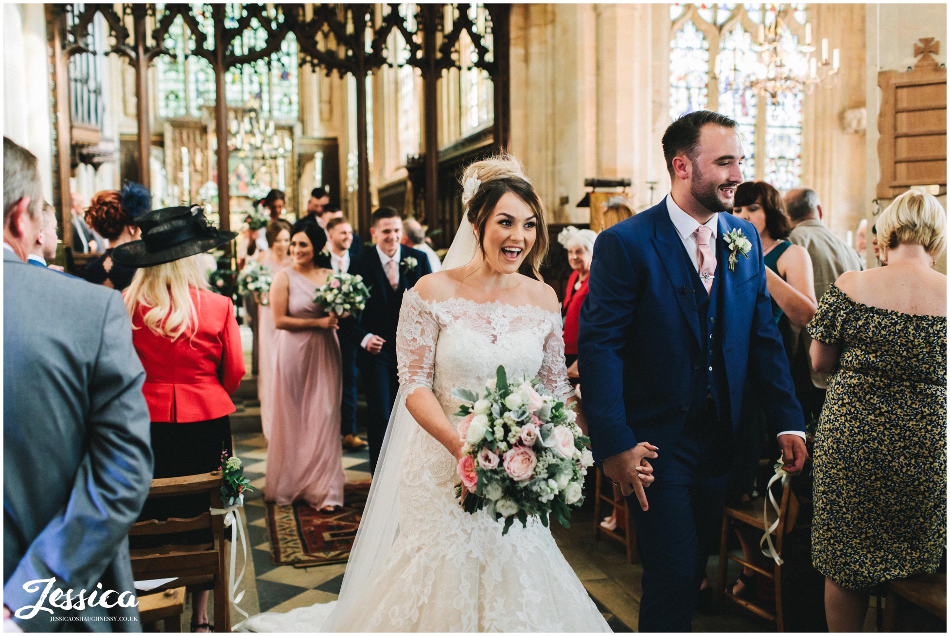 the couple walk back down the aisle as husband and wife
