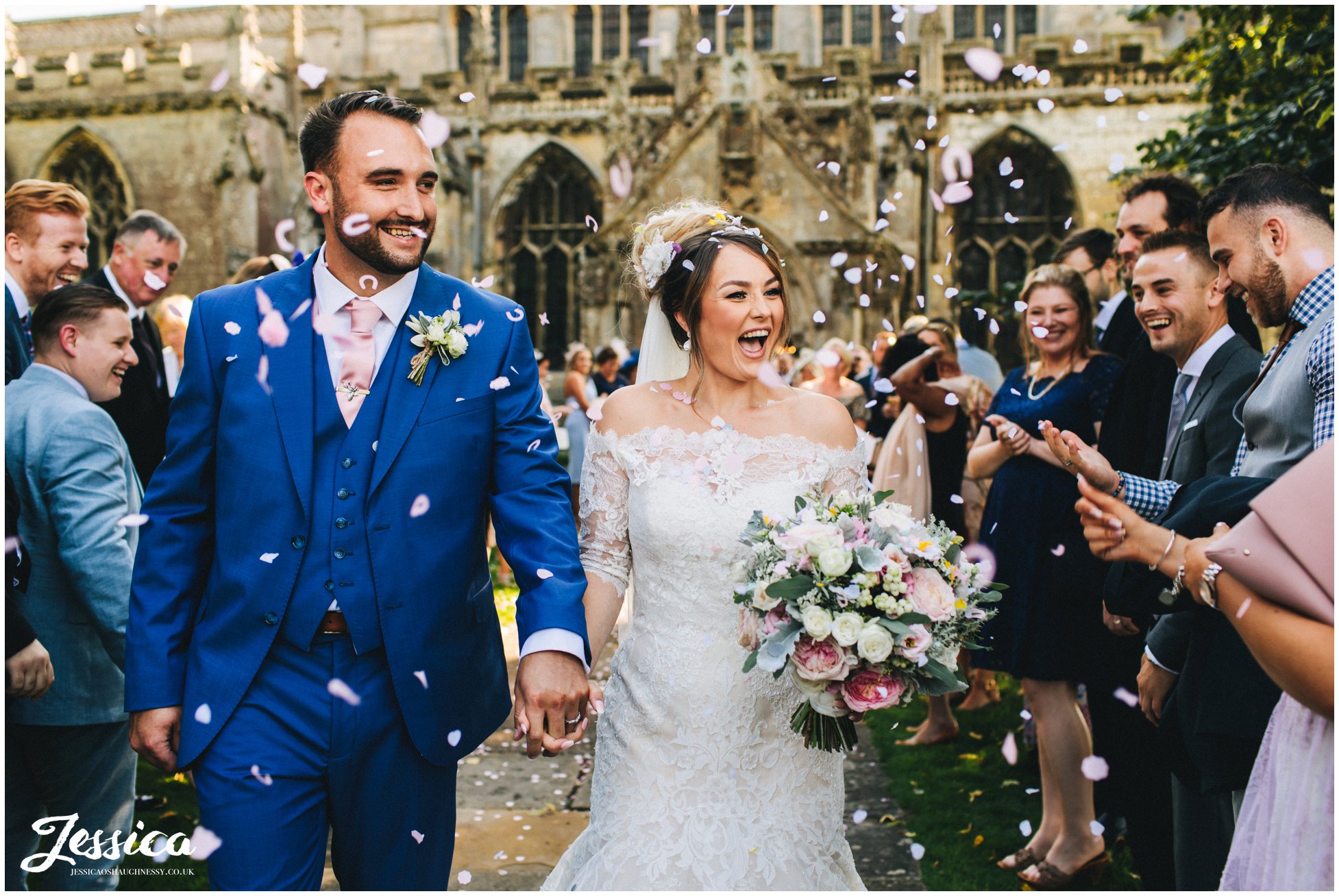 the couple are showered with confetti by their friends and family