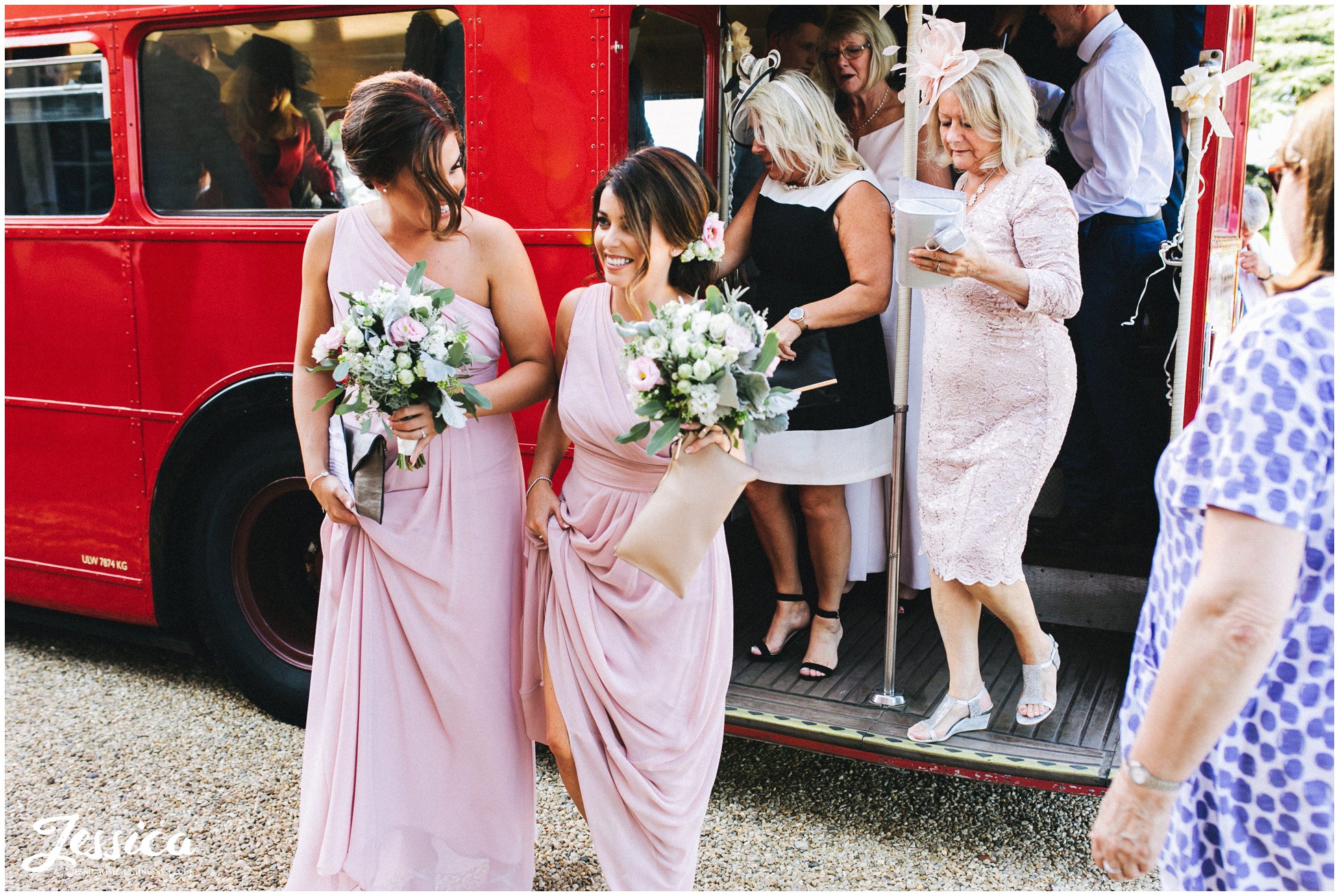 guests pile off the red bus back at the newark wedding venue