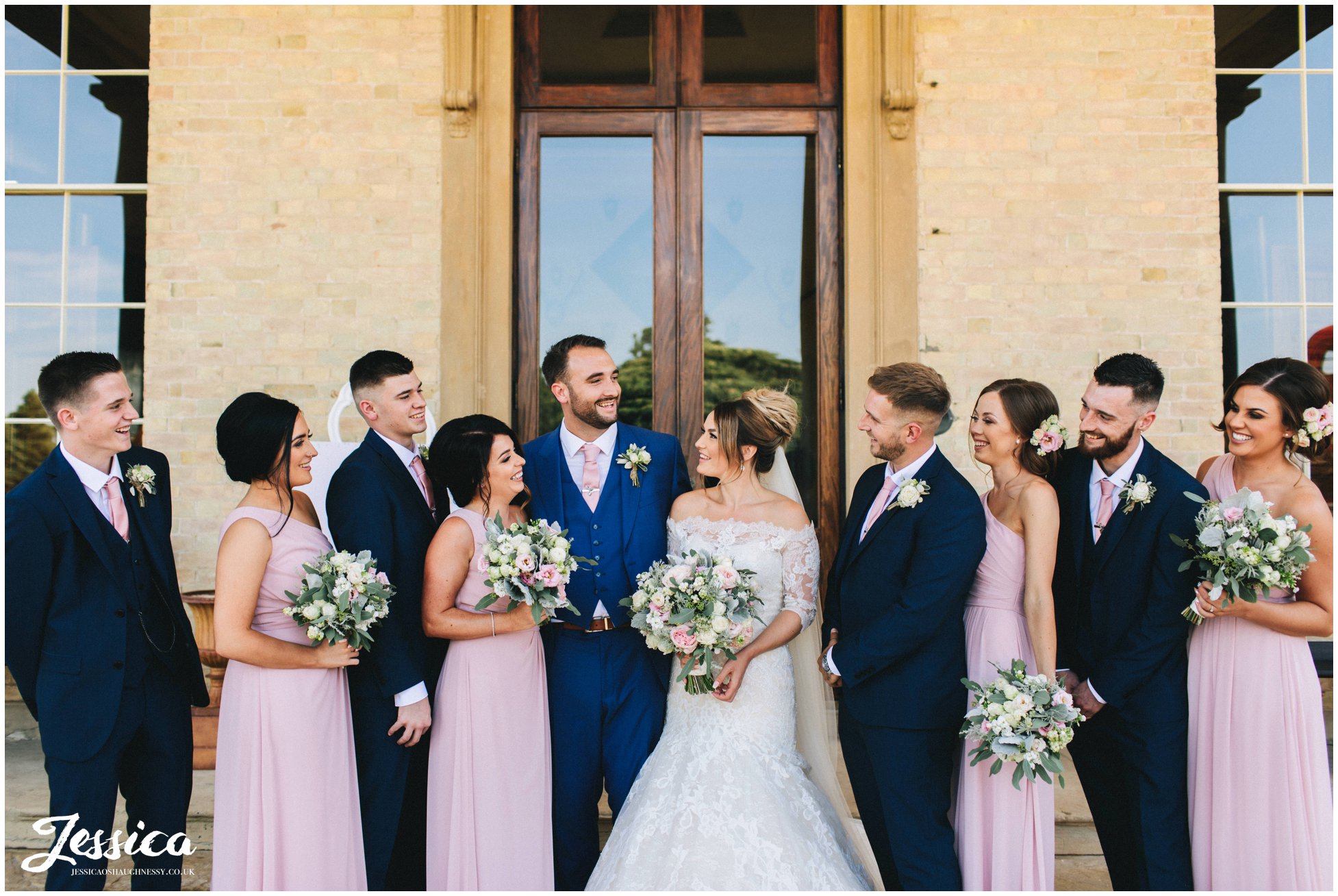 the whole wedding party laugh together