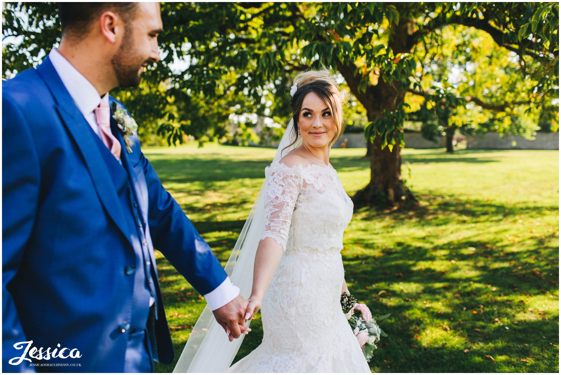 the couple walk through stubton hall's gardens