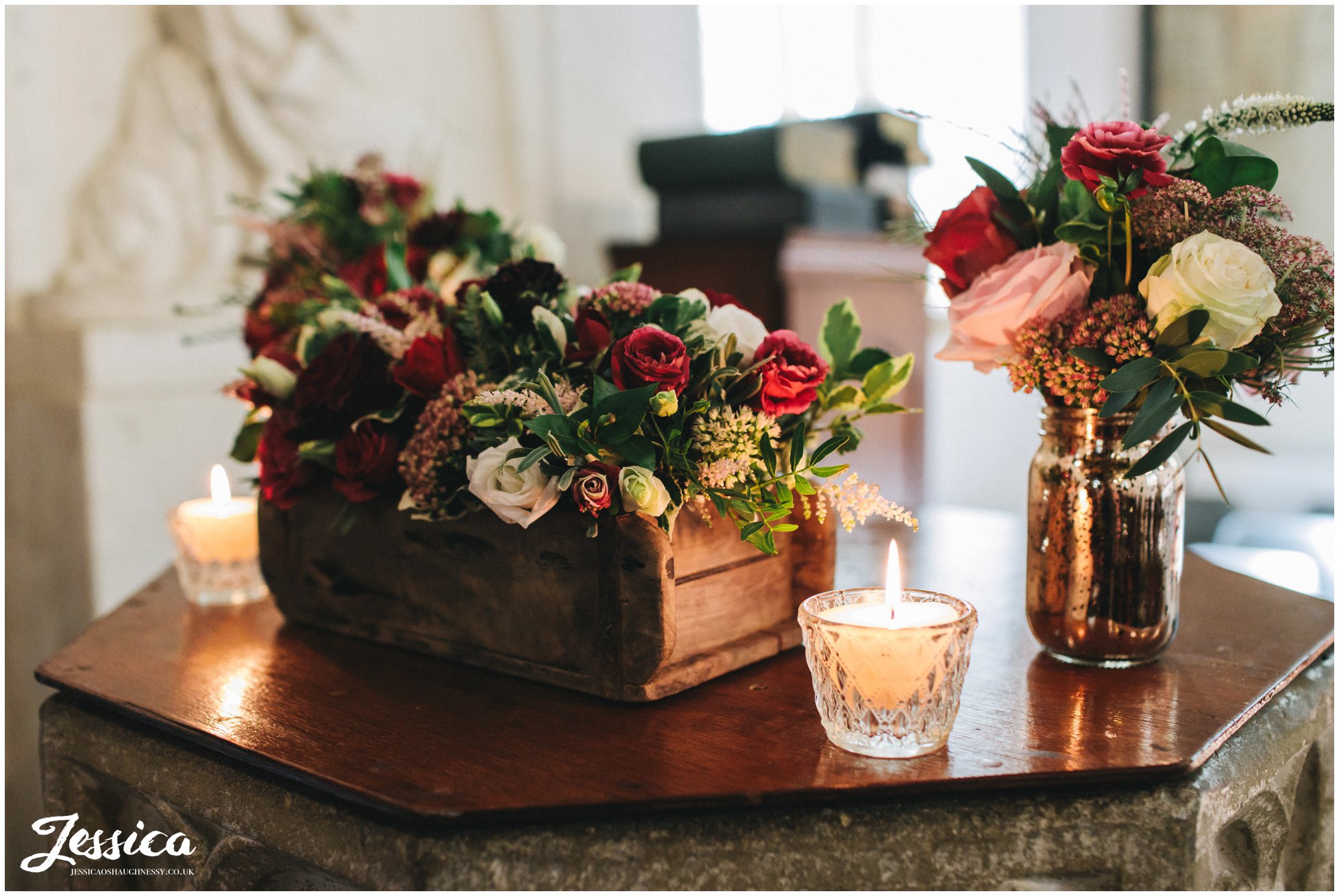 the church is decorated in rustic red flowers