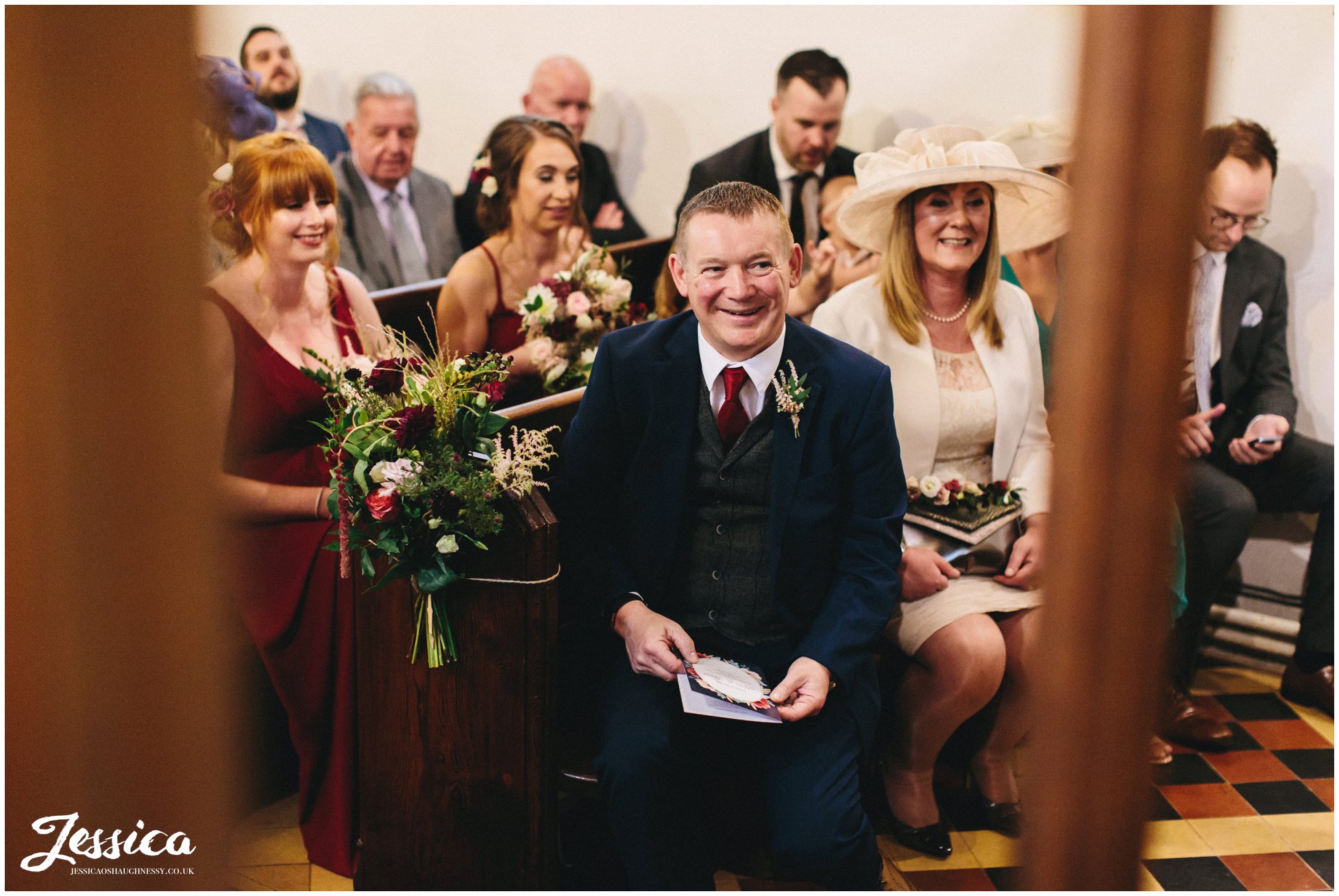 the brides family laugh during the wedding ceremony