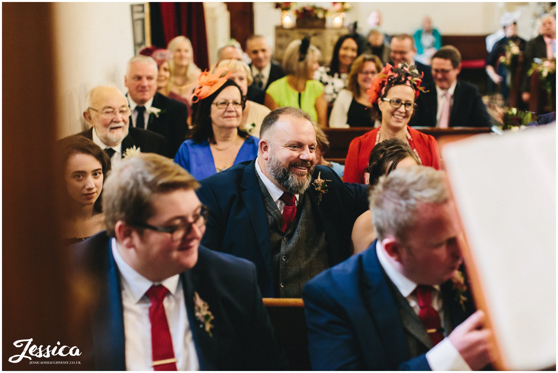 friends and family of the couple watch as they exchange vows