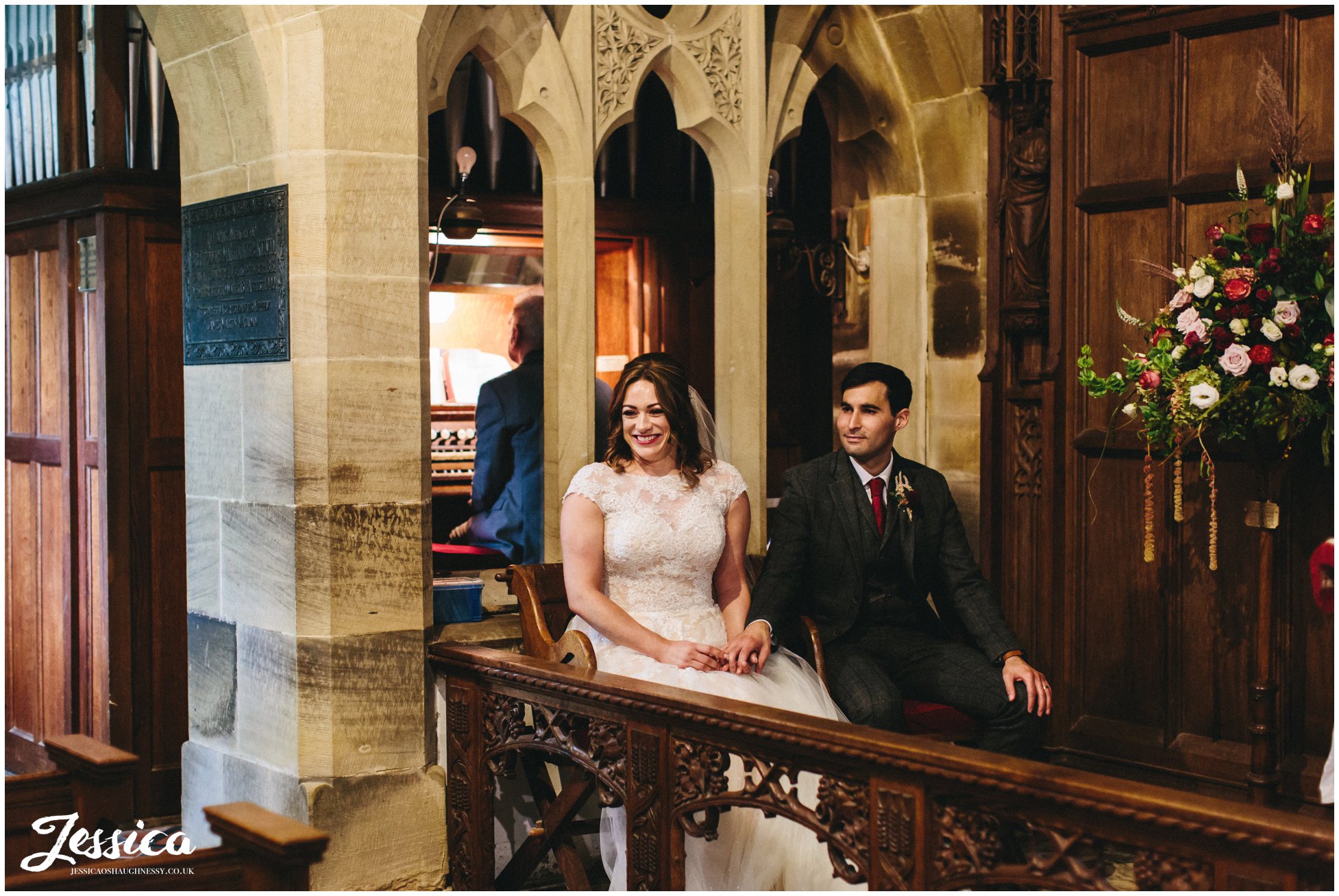 the couple sit during their wedding ceremony at Llantysilio church in north wales